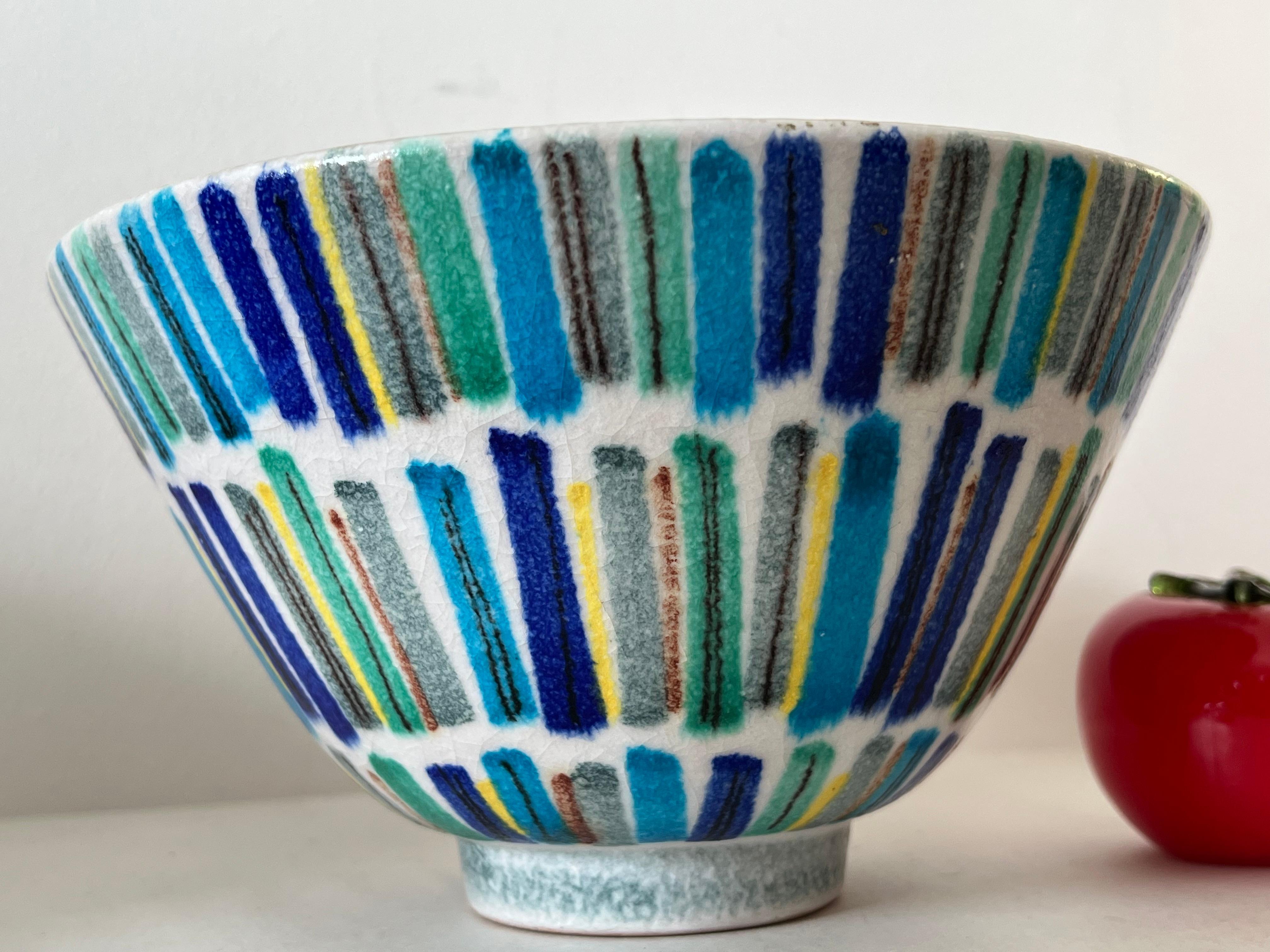 A rare and unusual bowl by Alvino Bagni, made for Raymor, ca' early 1960's. Blue, green, yellow stripes, hand painted, and blue inside. 