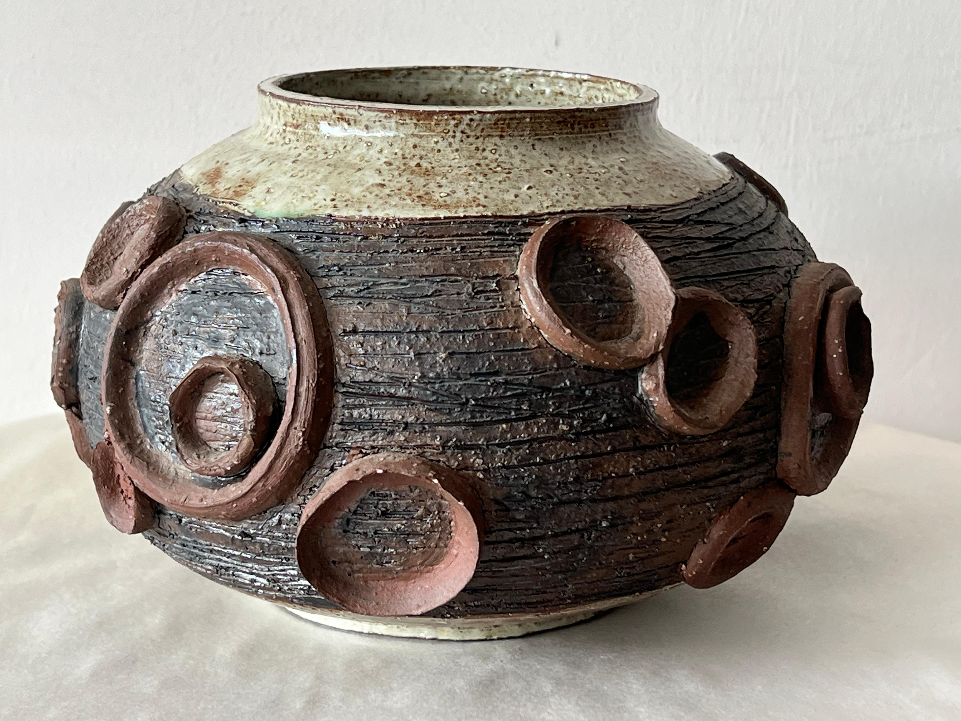
An unusual ceramic, studio vase by Elinor Jensen, ca' 1960's. Heavy, earth tones, decorated with concentric circles.


A note about the artist:
She was a member of the Ceramic League of Miami.
She operated her own studio, 
