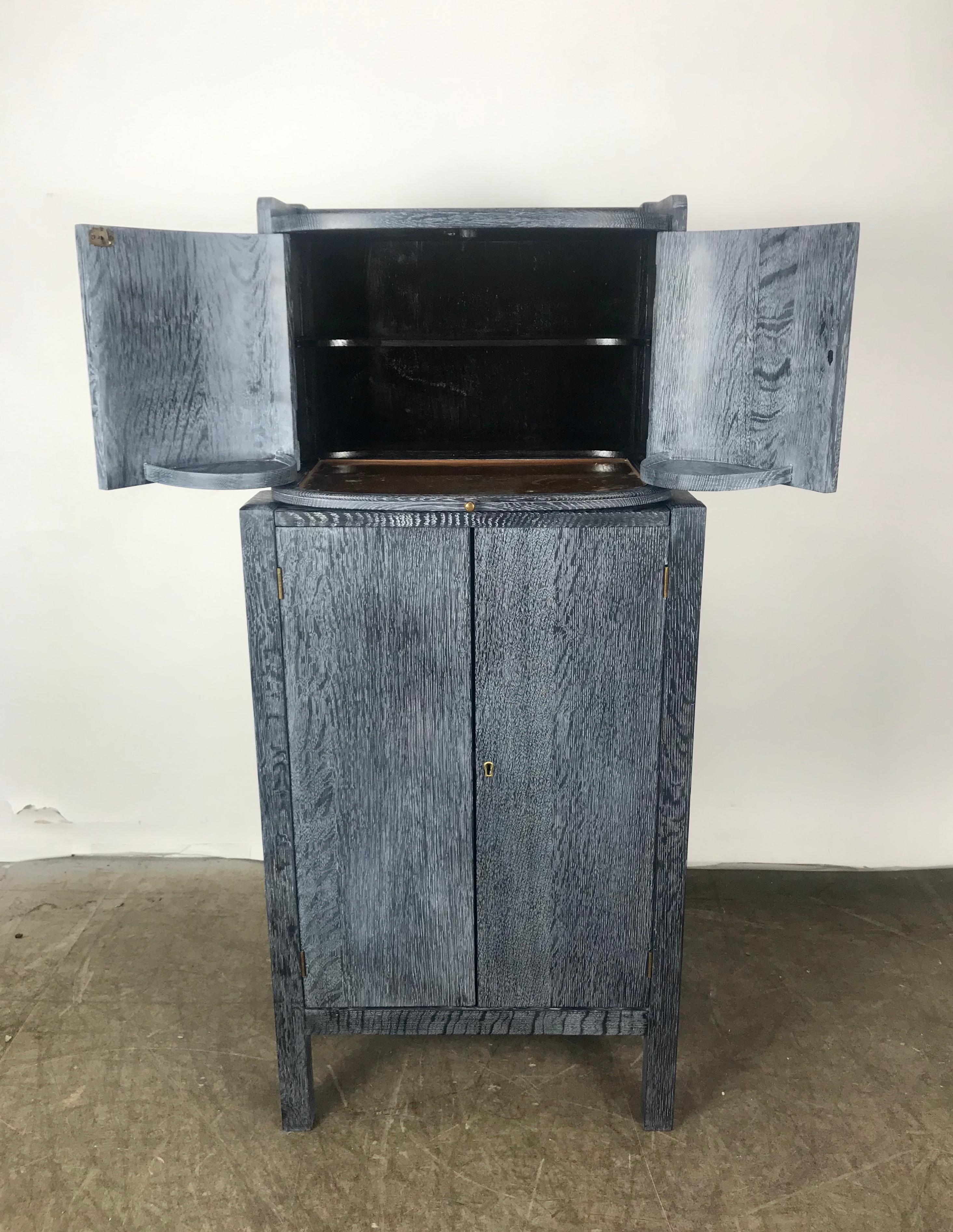 Unusual cerused oak Art Deco modernist gentleman bar /tobacco cabinet, 1940s. Retains original copper pull-out tray. Multi purpose, dry bar, wet bar. Cigar, tobacco storage cabinet, two doors on top with pull out tray for serving or cutting, larger