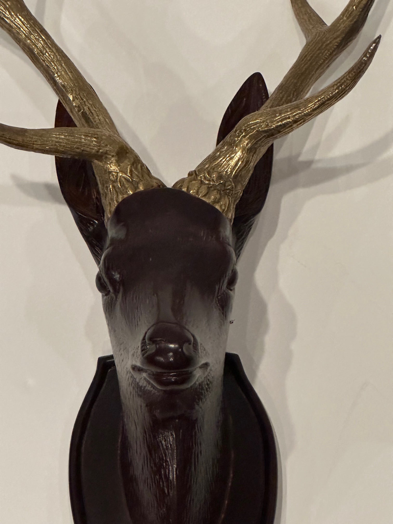 Wonderful wall sculpture of a hand carved wooden stag having striking brass horns.