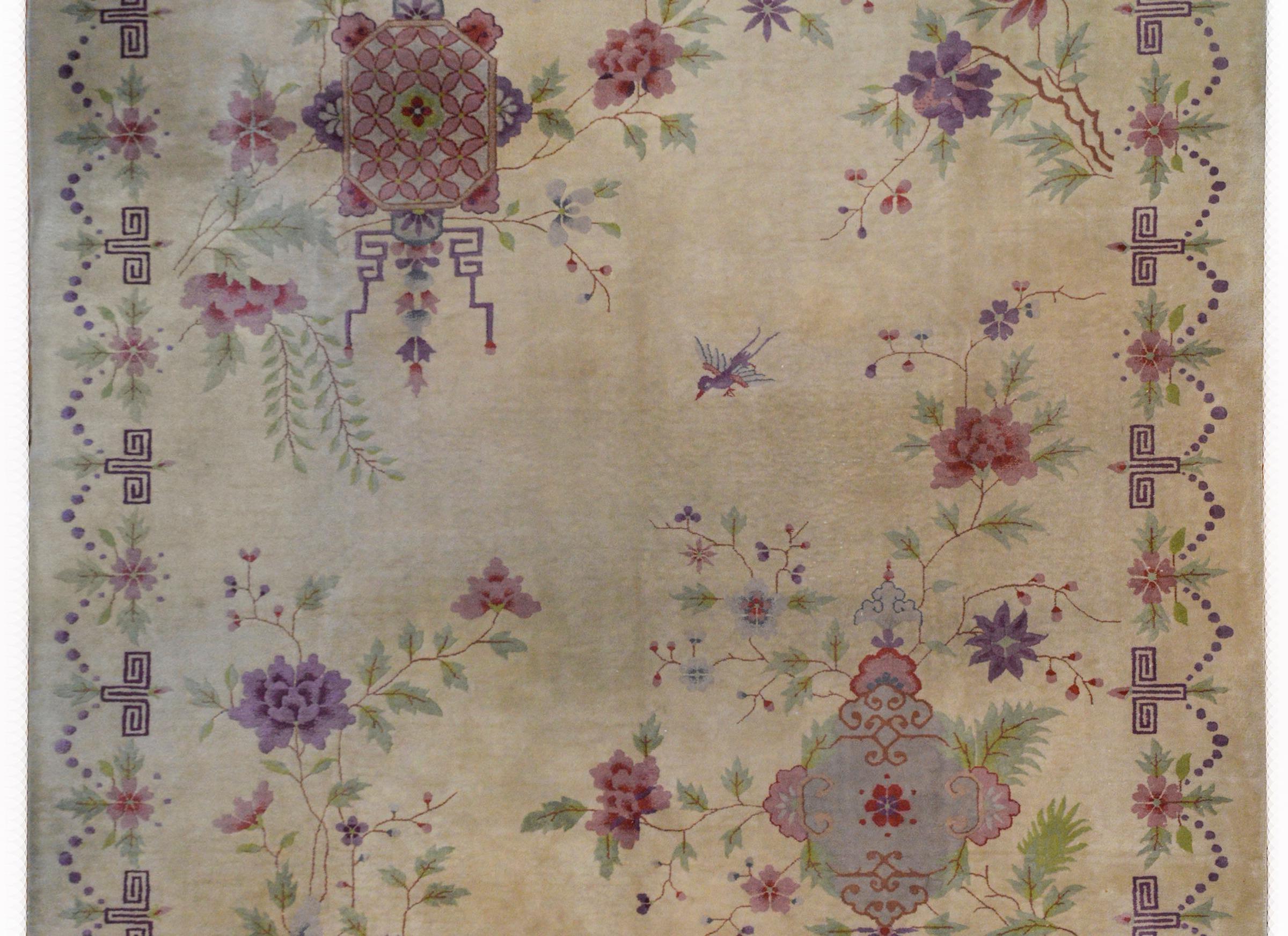 An unusual Chinese Art Deco rug with a beautiful and rare pattern with two large floral medallions in opposite corners with large peonies and scrolling branches and surrounded by a beautiful geometric and floral patterned border, all woven in pale