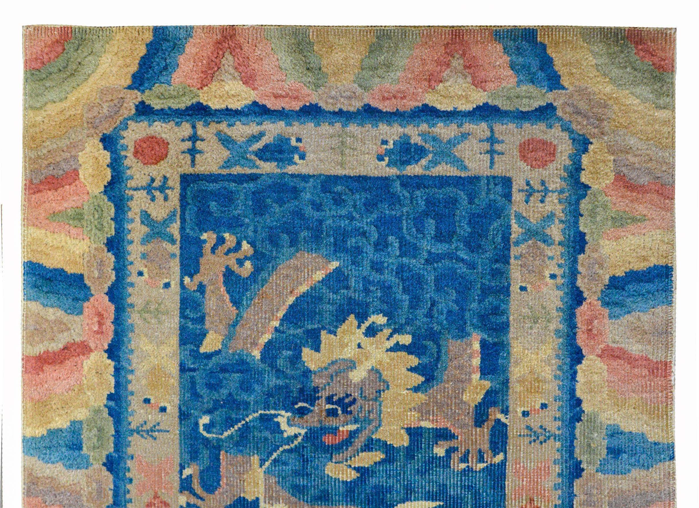An unusual Chinese Art Deco rug with two contrasting dragons, both peeking out from blowing storm clouds woven in cream and indigo, and surrounded by a border of more multi-colored turbulent storm clouds.