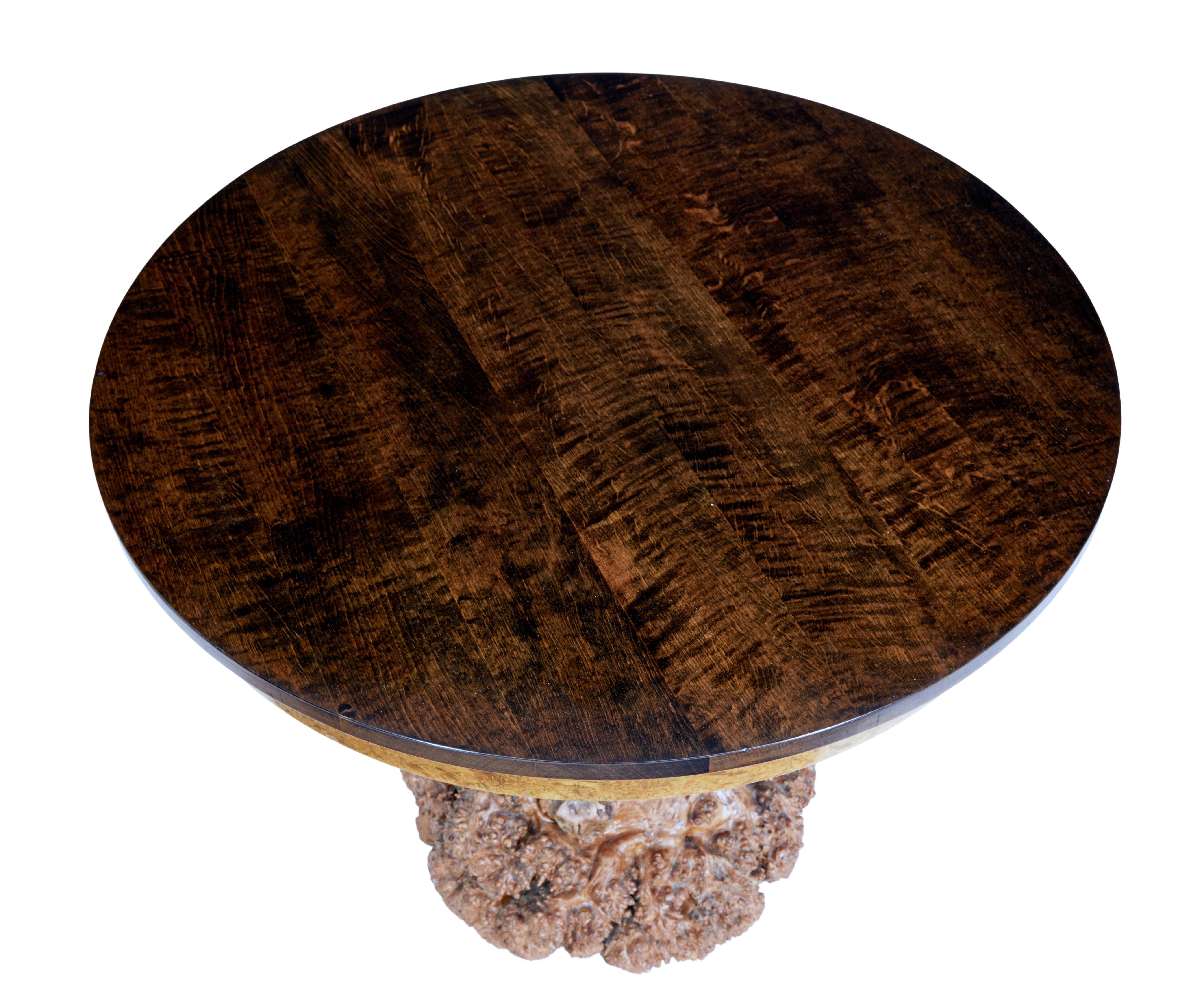 Unusual circular occasional table with burr root base circa 1930.

Recently re-polished dark stained circular birch top with burr frieze, standing on burr root base which has been adapted to work as a base.

Rich golden colour.

Minor surface