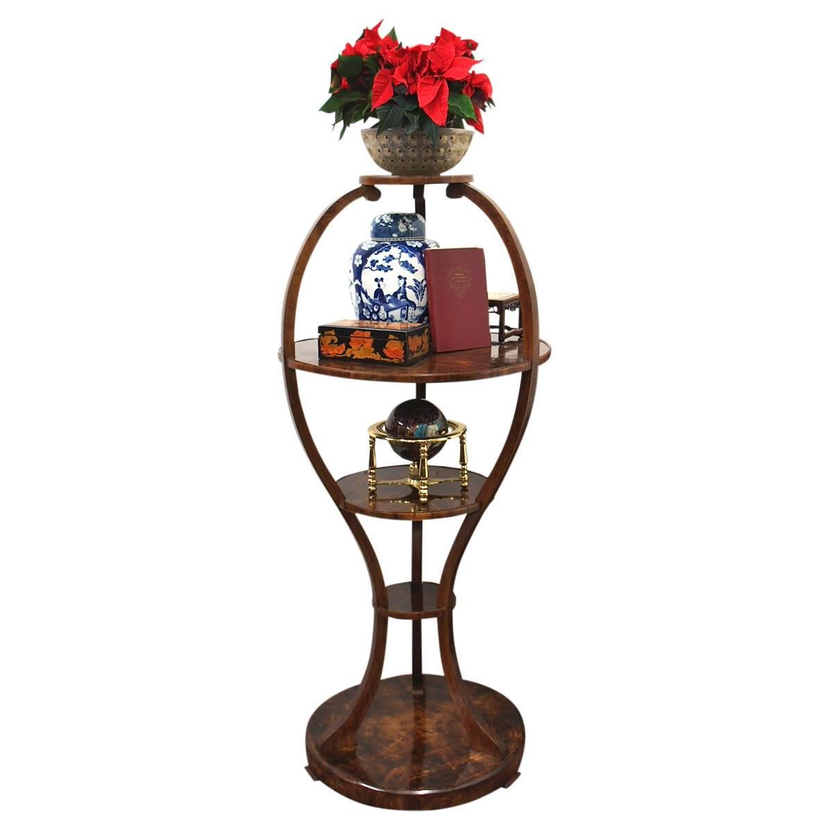 Unusual circular whatnot, circa 1900. With five shaped, circular shelves of various sizes held in place by curved uprights, and each shelf has segmented walnut veneers in a sunburst pattern. It all stands on a circular plinth with a segmented wood