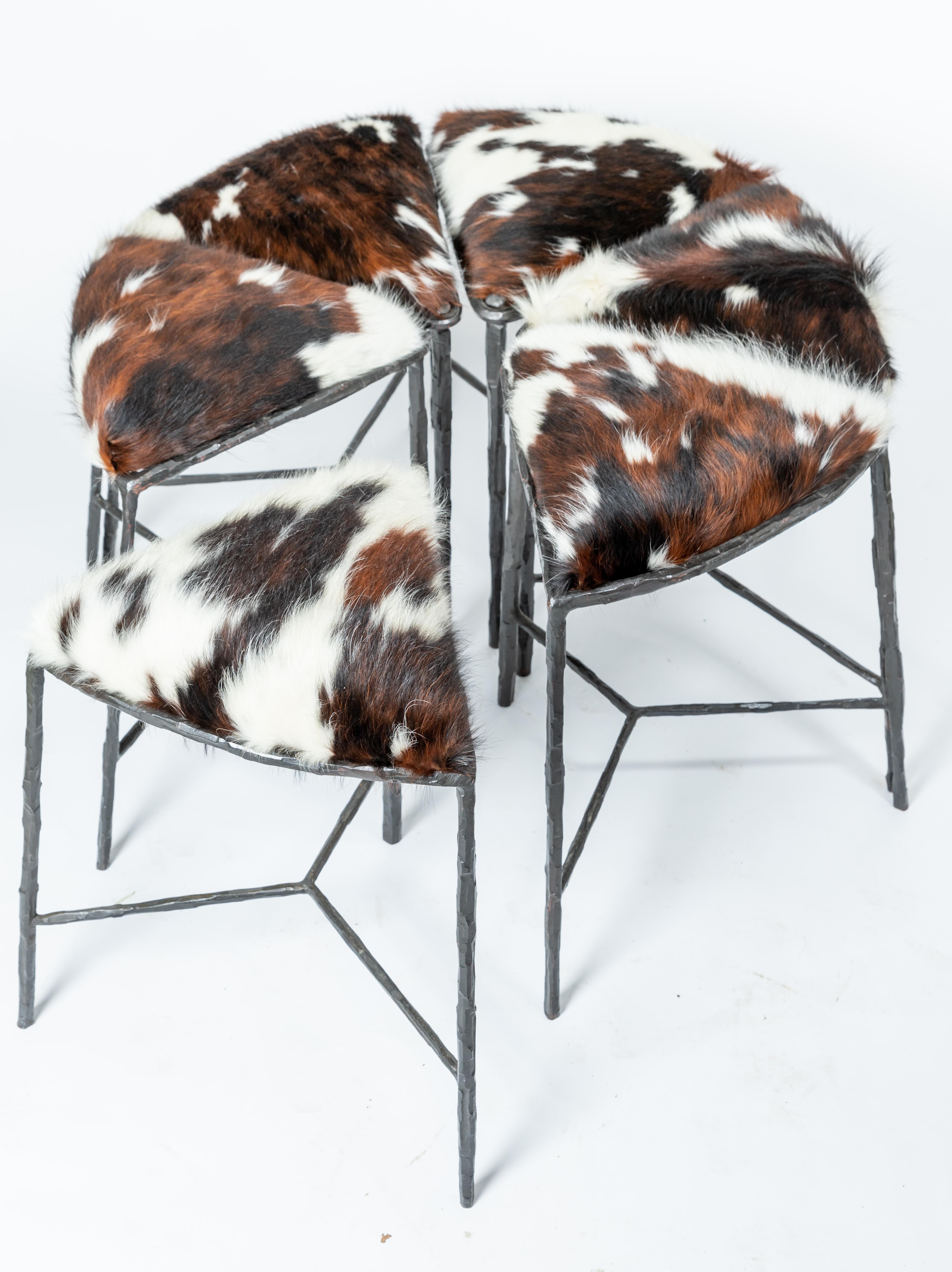Unusual cluster of six pie shaped hide upholstered seat and blackened iron benches.