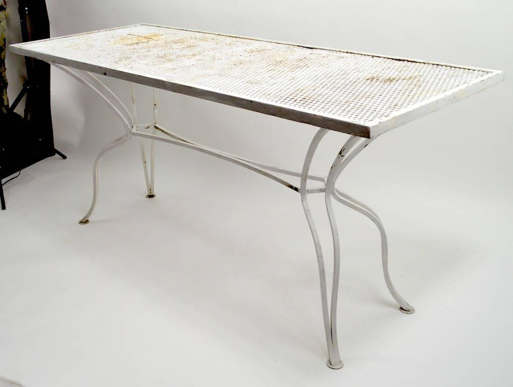 Metal mesh top on sinuous wrought iron legs, unusual form not often seen, console or serving table attributed to Salterini. Currently in white paint finish, which shows wear, usable as is or we offer custom powder coating if you want a more polished