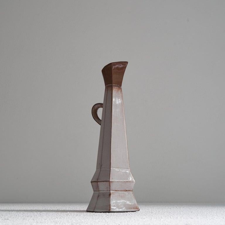 Unusual Cubist Studio pottery pitcher vase. Mid 20th century.     Very unusual and asymmetrical studio pottery pitcher vase with an attractive colorful glaze. Interesting cubist shapes and sharp angles give it a very distinct appearance. Therefore