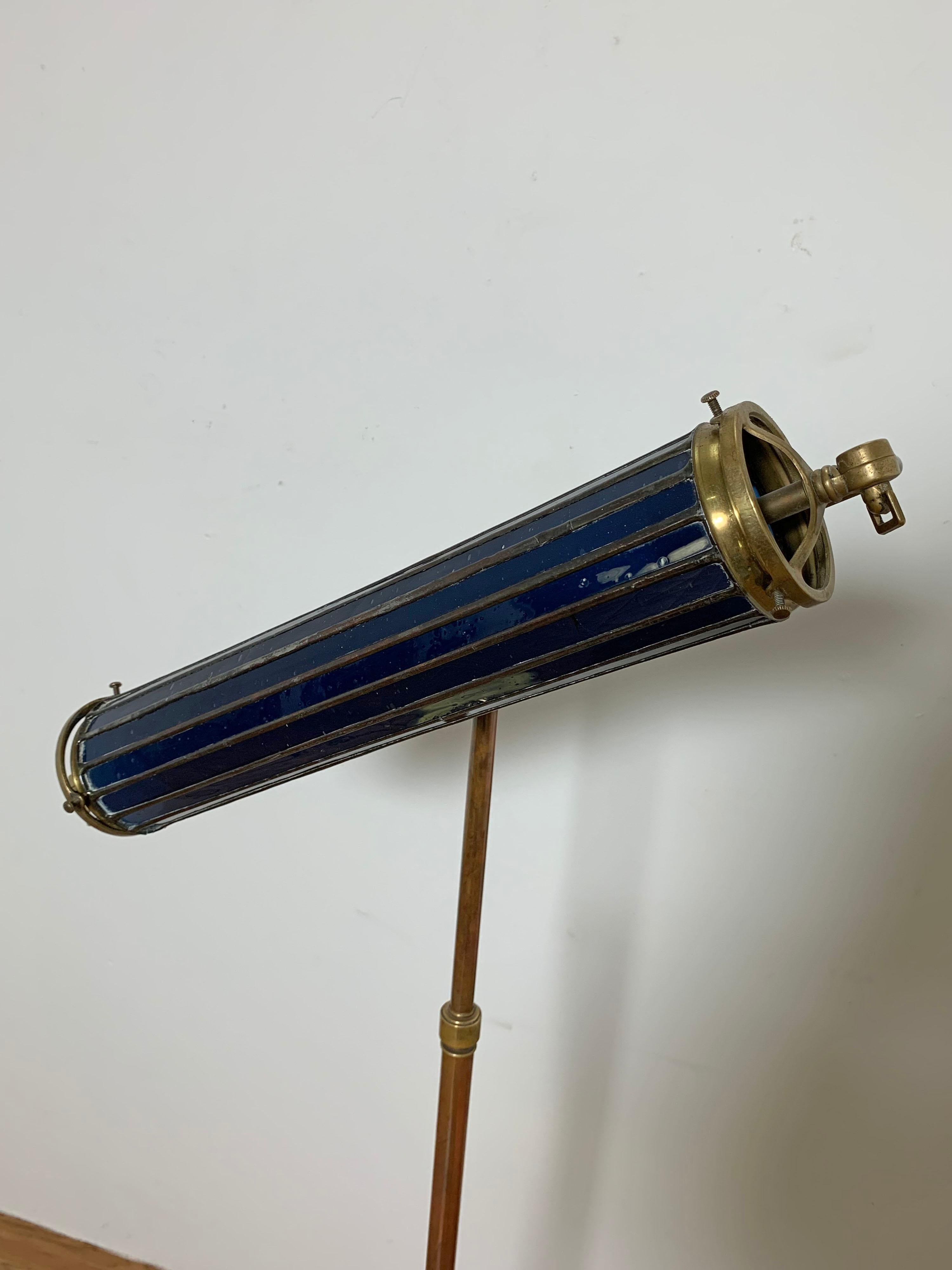 An unusual one of a kind lamp, circa 1920s with polished brass base and sophisticated mounting hardware for a leaded cobalt glass cylinder shade. The high quality craftsmanship indicates this was likely a custom made piece, made to the
