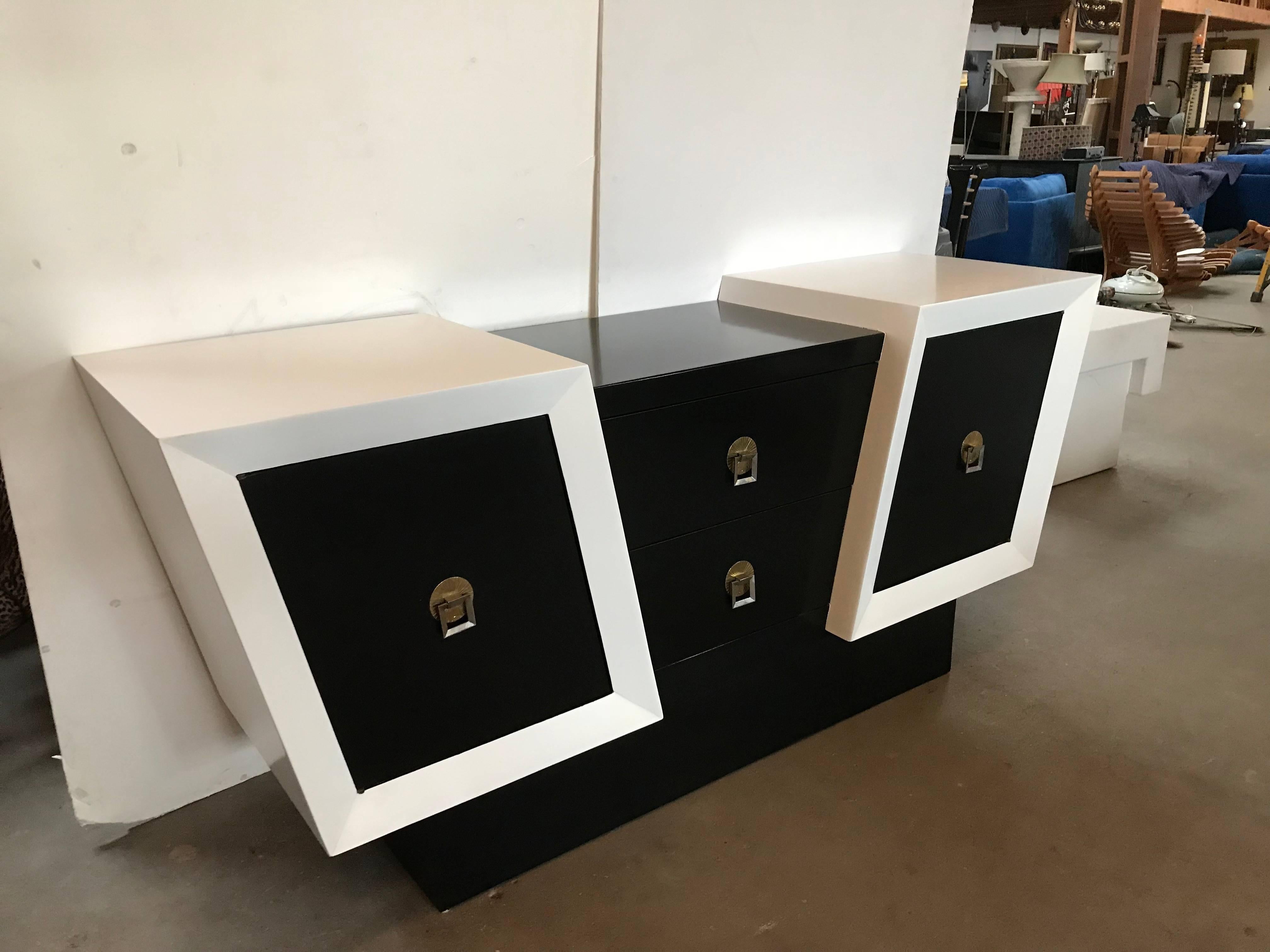Unusual oak credenza in black and white lacquer with brass-plated hardware. Unique diagonal design has two pull out drawers as well as doors on either side that open to reveal shelves. Newly refinished. 


Not only would you have an incredible