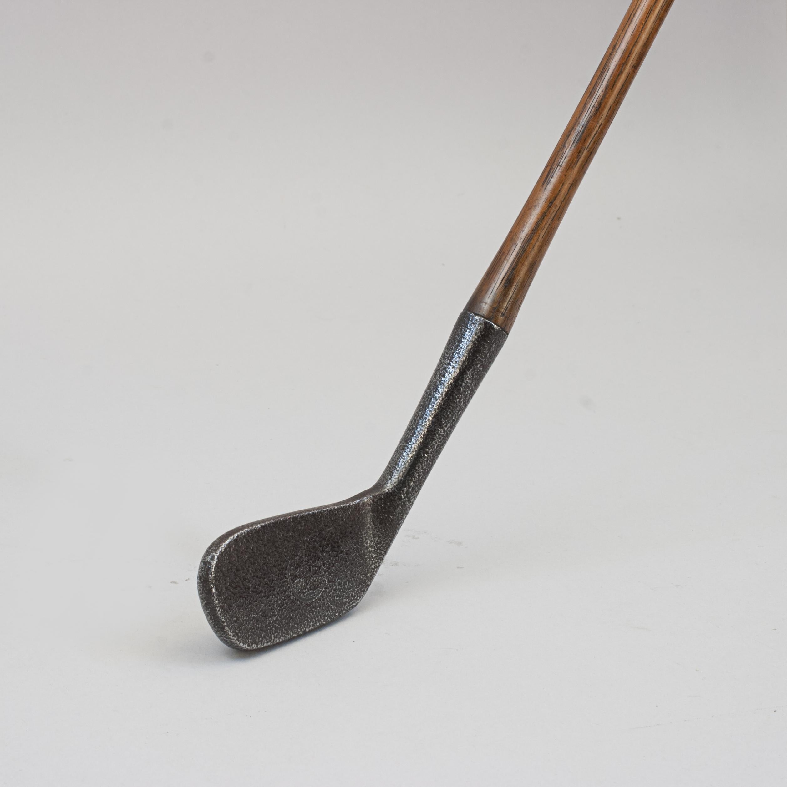 Unusual Driving Iron Golf Club, The Nipper 
This rare and unusual hickory shafted iron 'The Nipper', has a smooth face, bulbous weighted back, hickory shaft and suede leather grip. The rear of the head stamped 'D. Myles, Dundee. 7 Nipper', the face