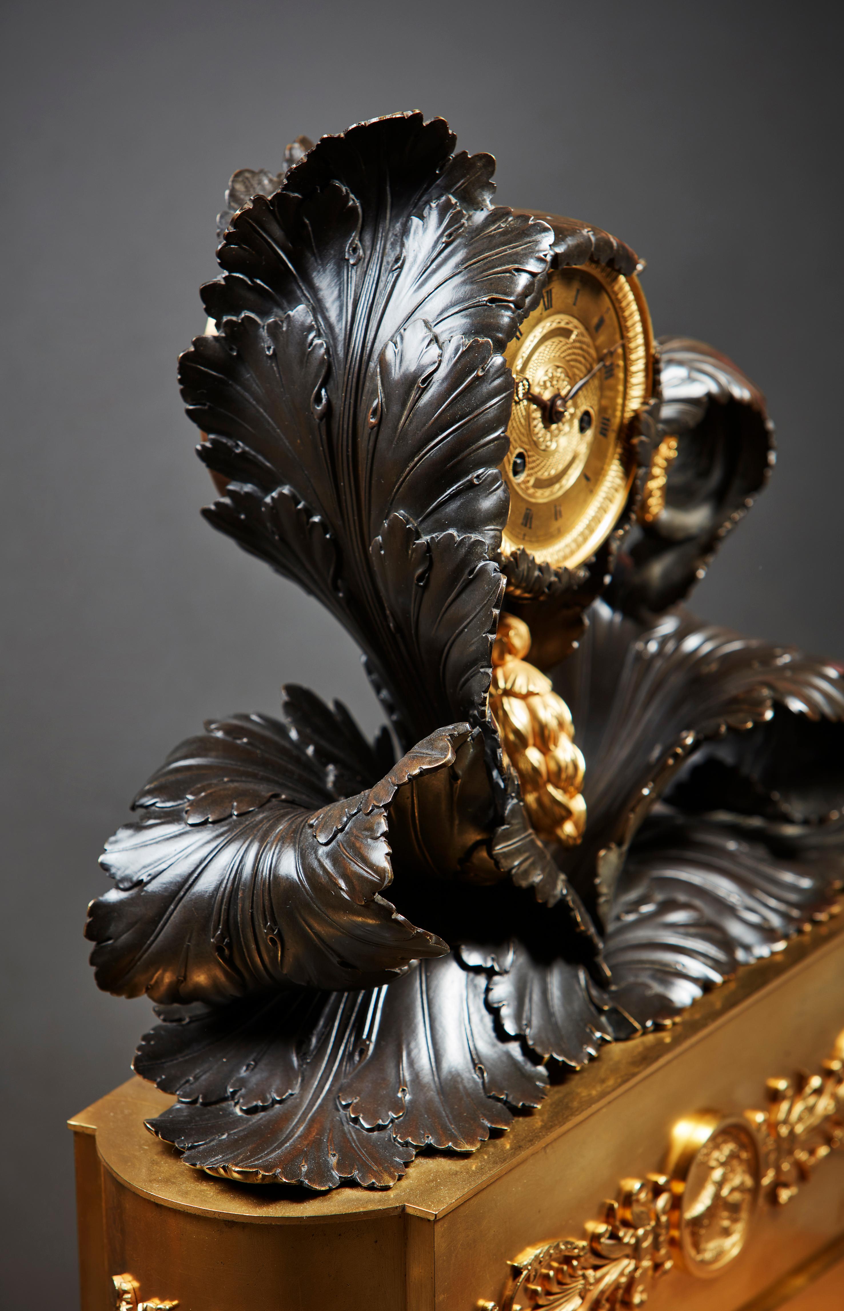Exceptional French Empire Mantel Clock in Gilt and Patinated Bronze
A rare and visually arresting French Empire mantel clock, masterfully crafted in the form of a sculptural acanthus plant. The movement is playfully and ingeniously enveloped by