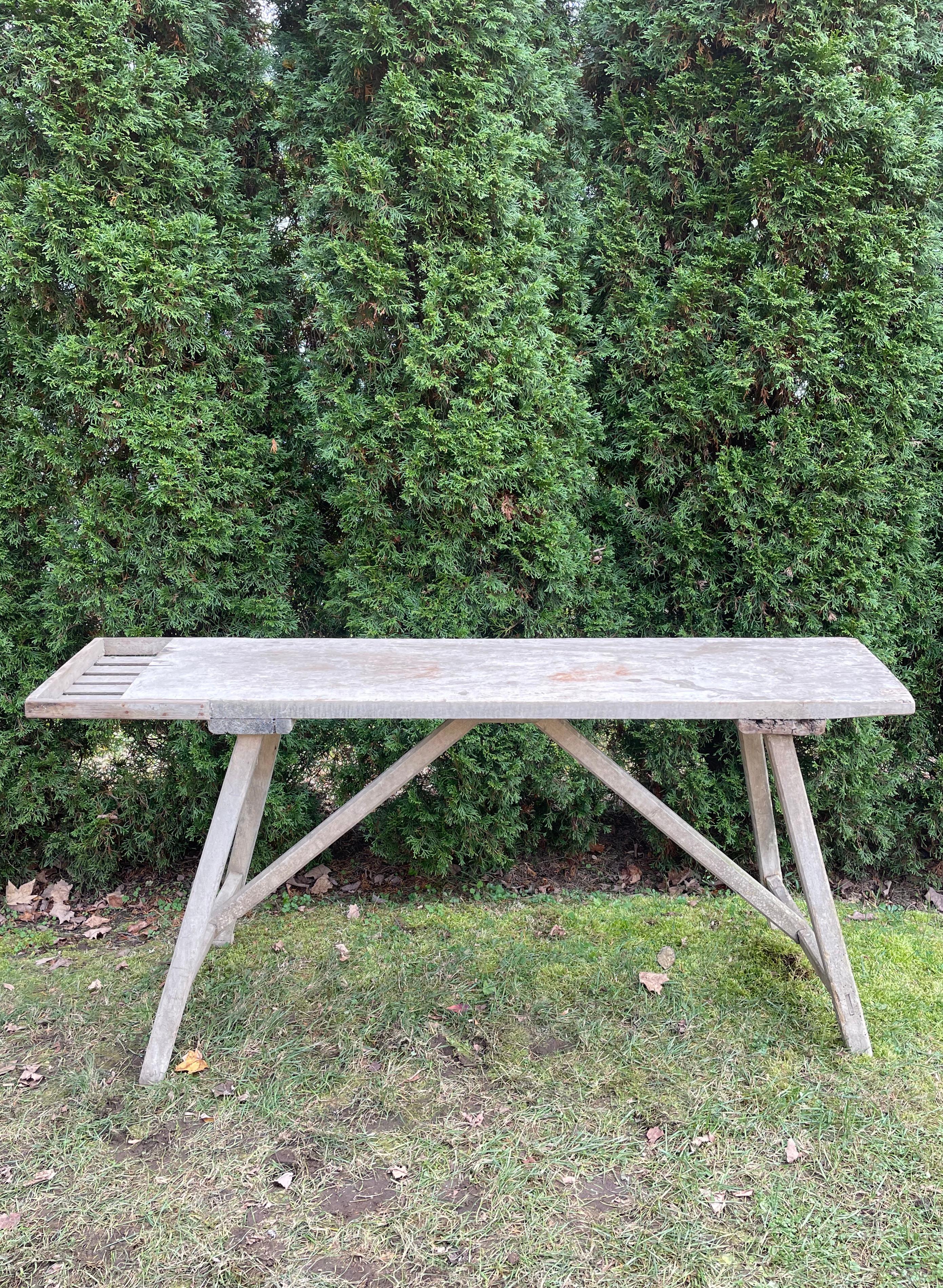 We love French washing tables and this one is most unusual. The slotted extension to the top was used for holding soap and scrub brushes, but makes a great spot to store TV controls and the like. Made of pine, it has been scrubbed to a lovely pale