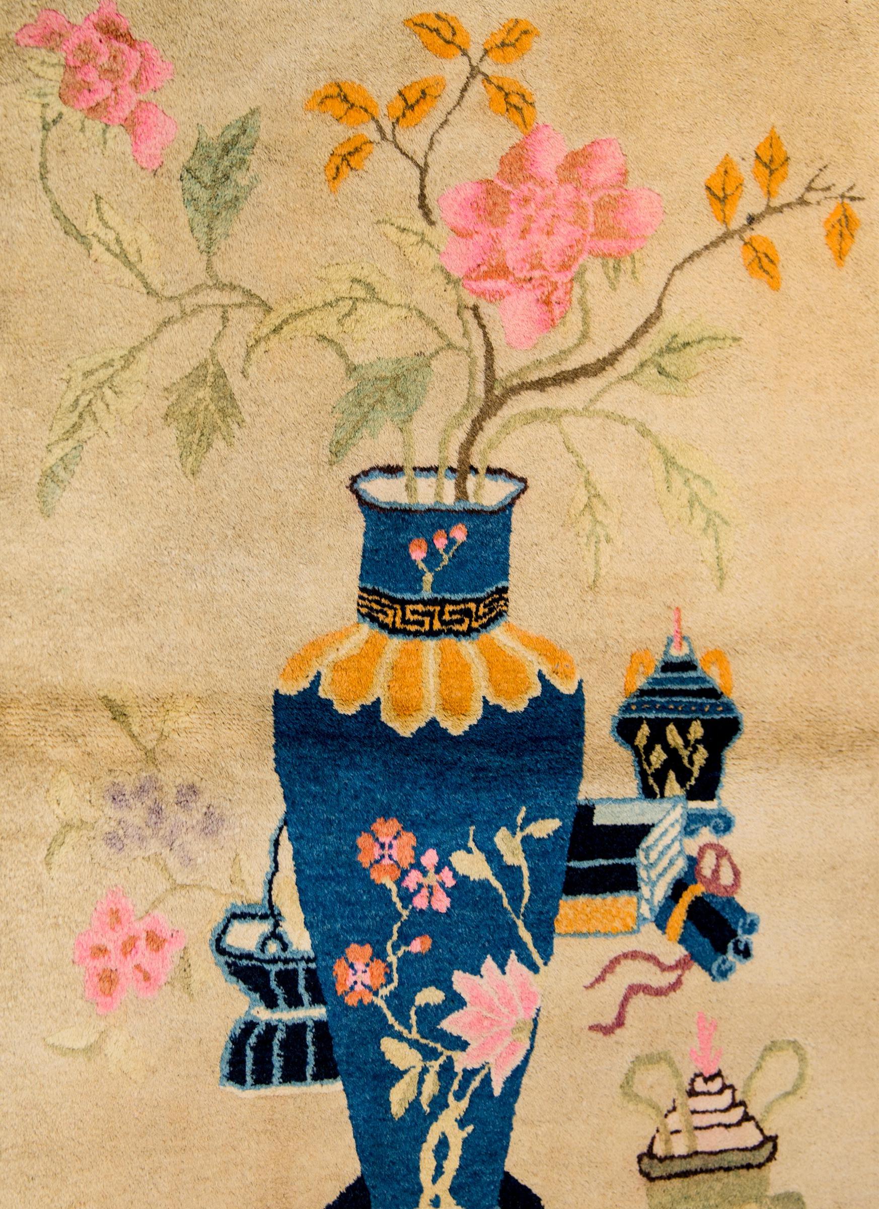 An unusual early 20th Century Chinese Art Deco rug with a large vase decorated with peony blossoms and filled with flowering peony branches. A fish bowl with two gold fish are in the background, along with an incense burner and other scholar's