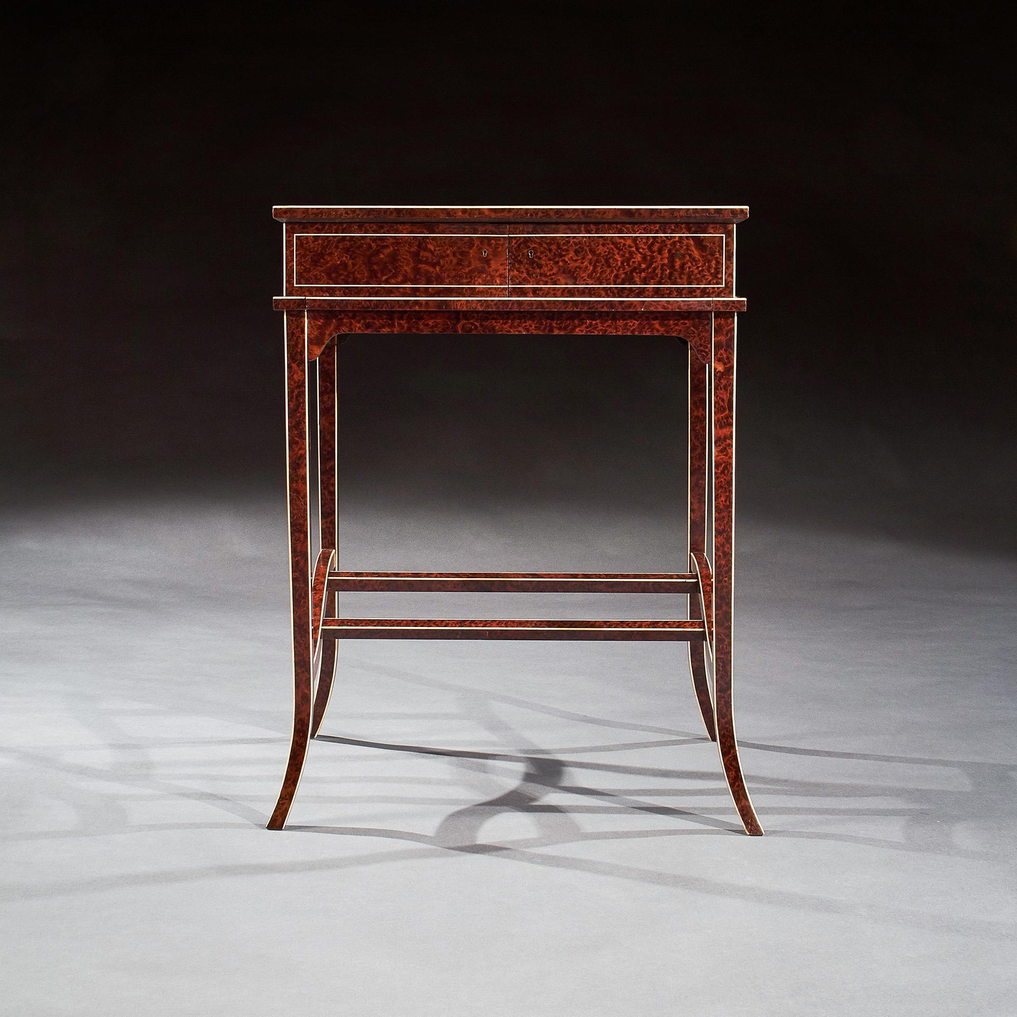 A very elegant and stylish thuya wood metamorphic writing table with ivory stringing and tulipwood crossbanding. 

French, circa 1910-20.

Inspired by the late 18th Century neoclassical designs (particularly those of Thomas Sheraton) this extremely