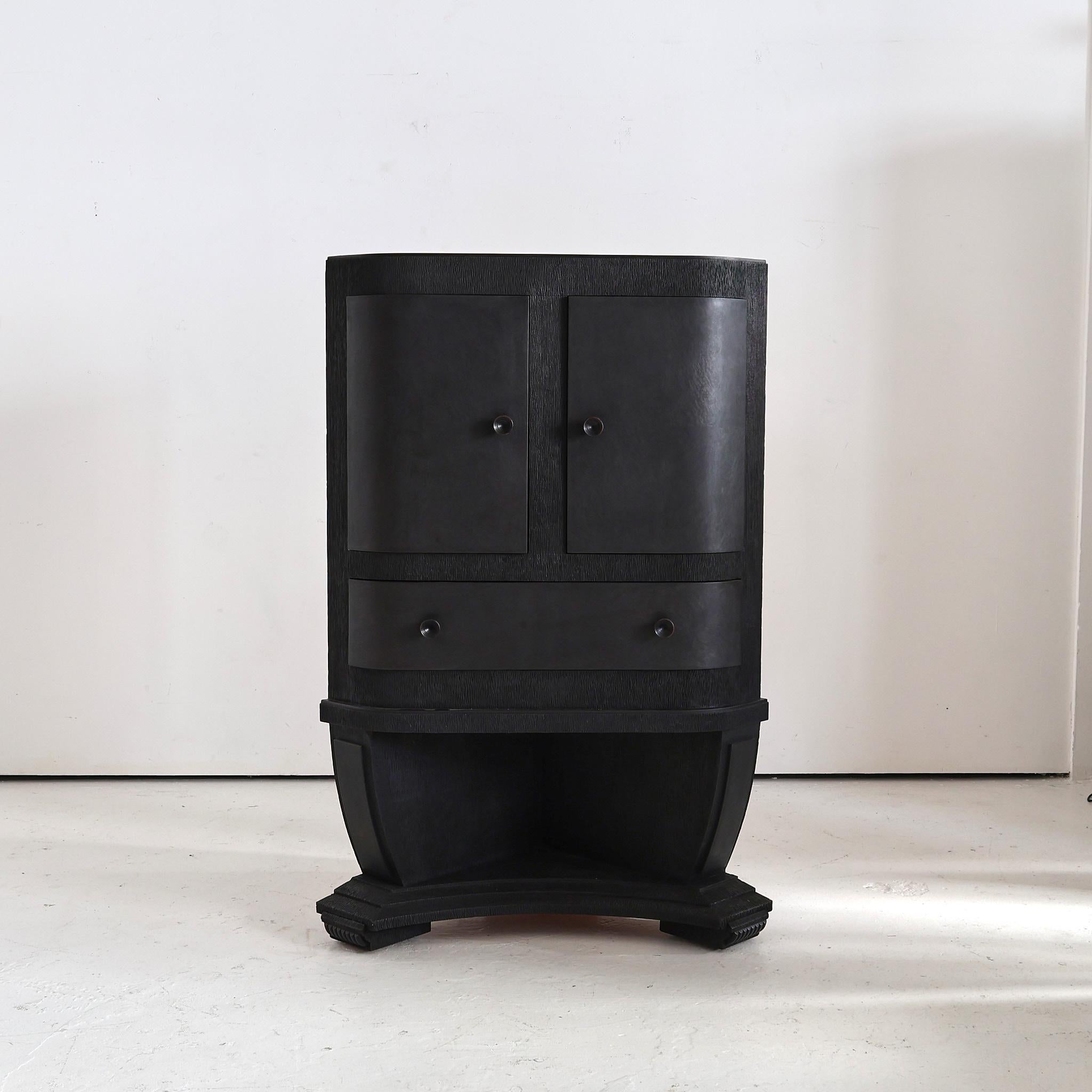 An eboniesd C.1930s bar/corner cupboard from northern Italy.

Unusual gouged texture to carcass with smooth curved doors and drawer.

Recently sympathetically restored in our London workshop.
