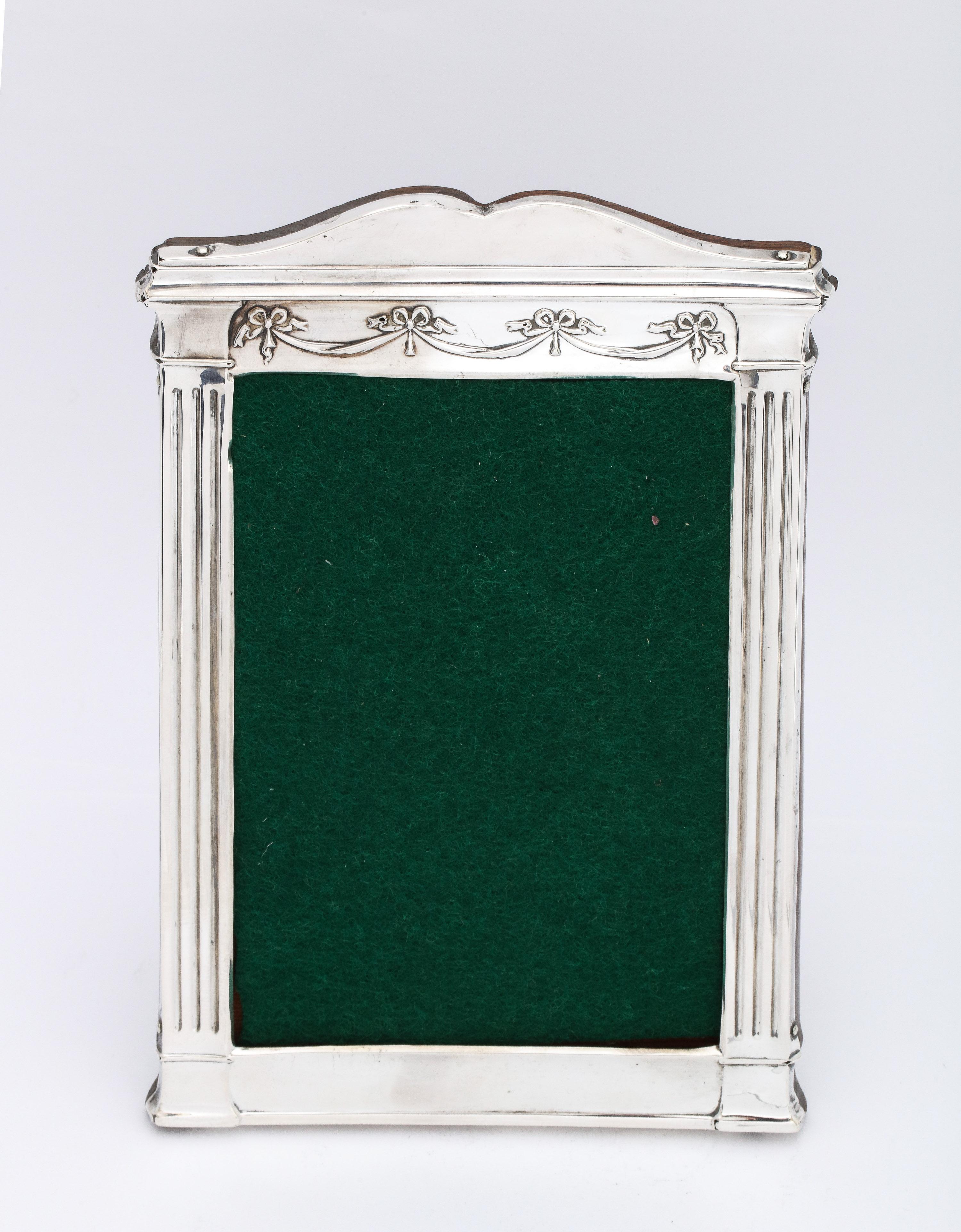 Unusual, Edwardian Period, Neoclassical style, sterling silver wood-backed picture frame, Birmingham, England, year-hallmarked for 1911, H. Matthews - maker. Designed with swags that drape across the top of the frame and column-form pilasters on the