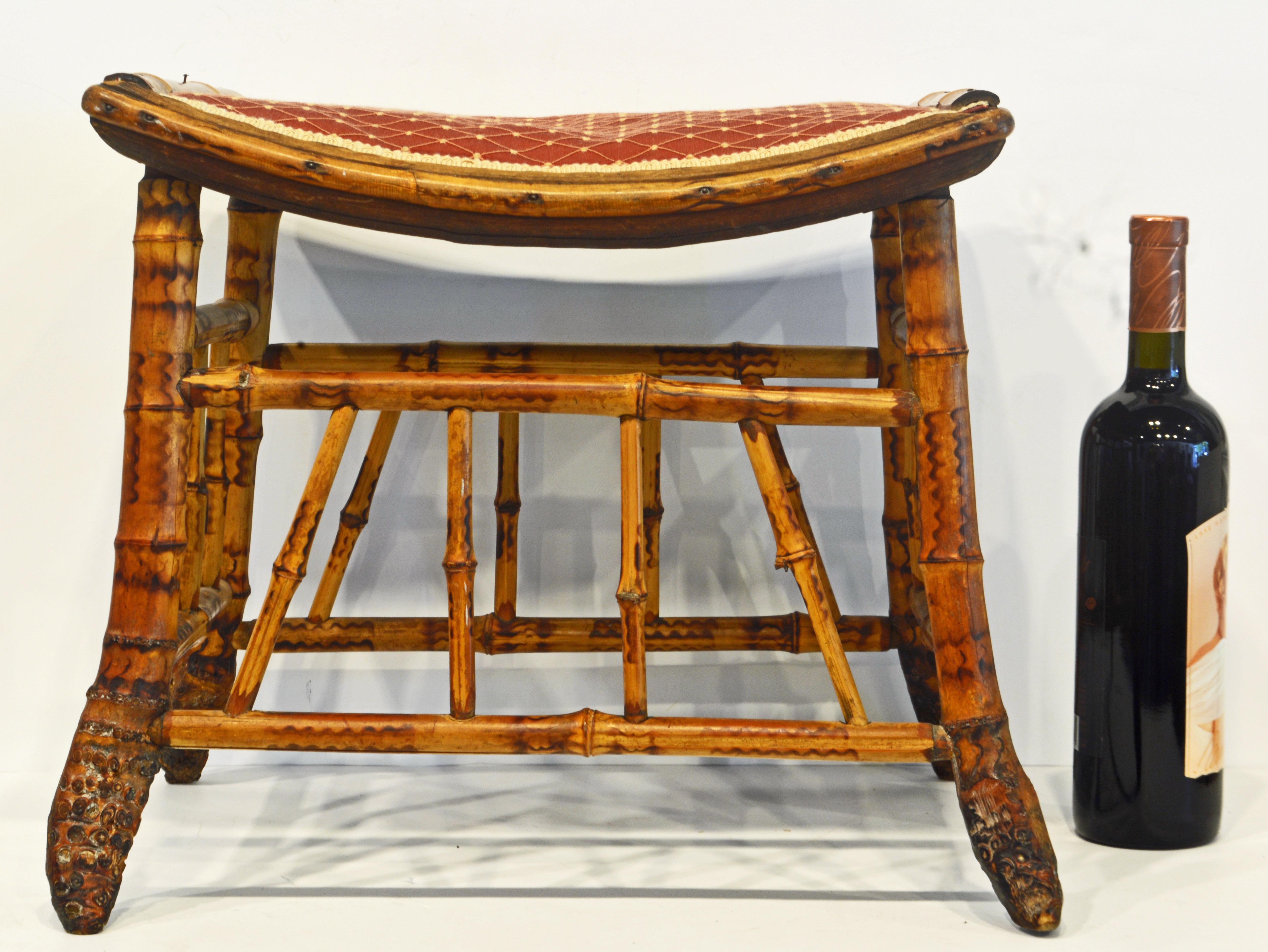 This is an unusual and well designed piece of English bamboo furniture dating to the late 19th century. The seat has an attractive curve and is covered with thin upholstery and tasteful fabric.