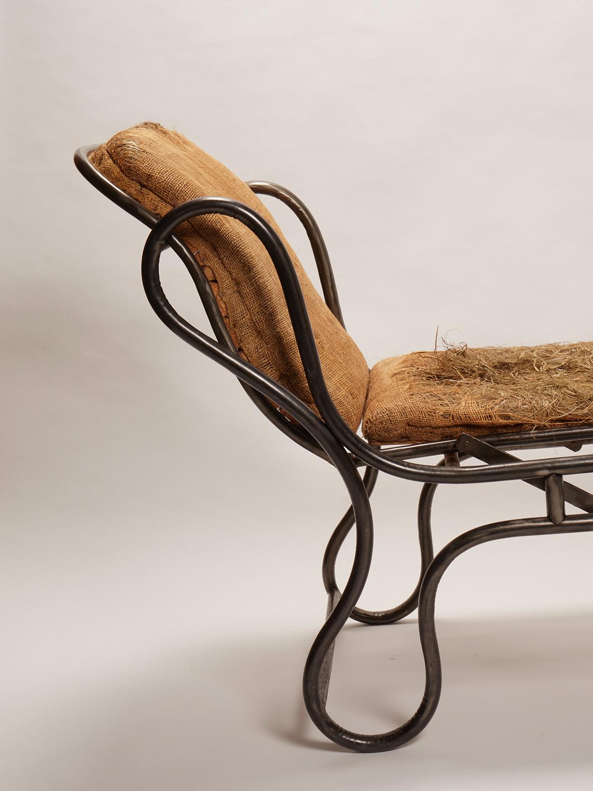 Adjustable chaise-longue. Very rare and unusual example of design for a chaise-longue. The structure is made out of curved iron. By lifting the foot's side of the chaise, the entire bed rise. France, circa 1900.