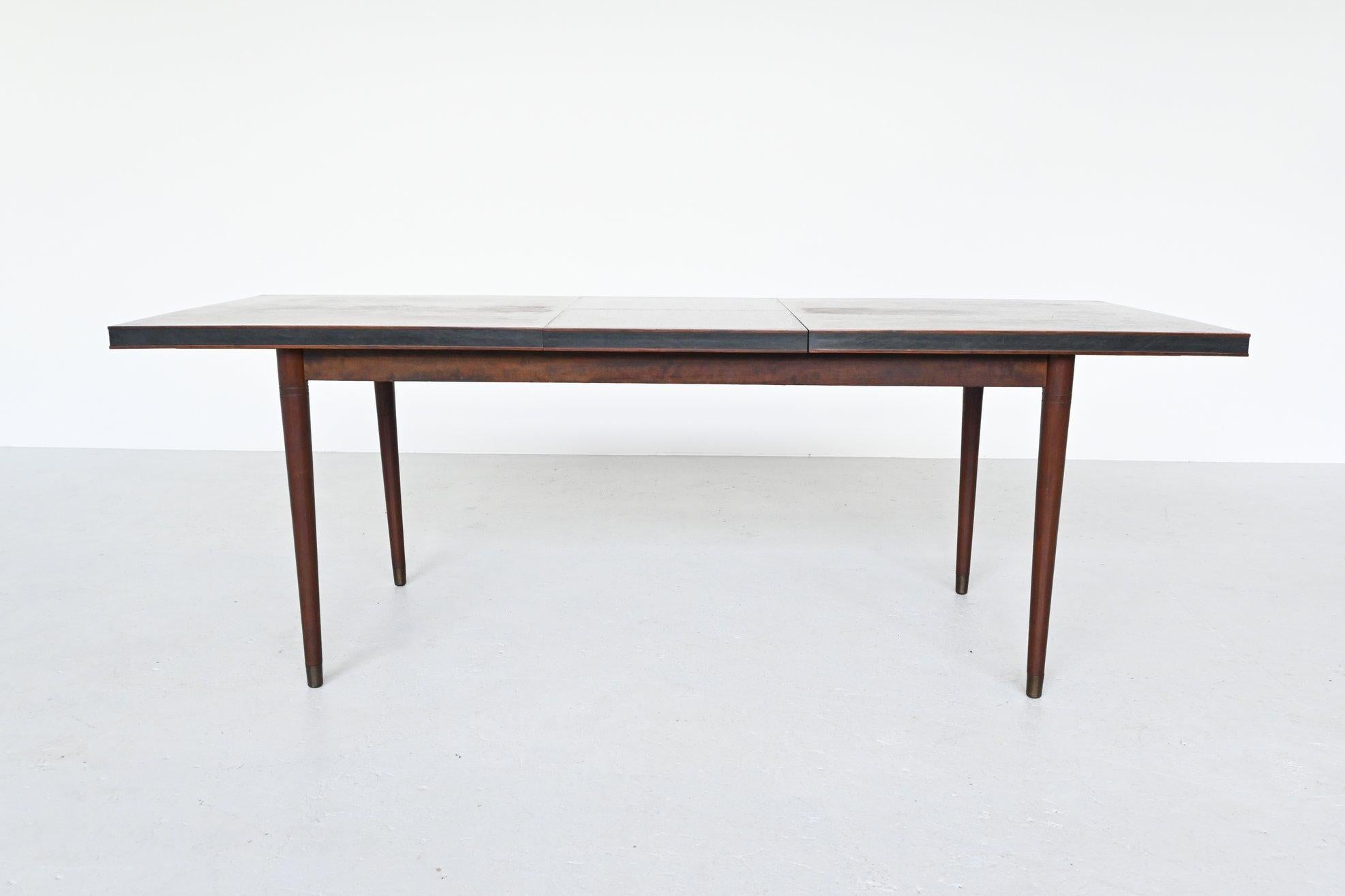 Beautiful shaped rosewood extendable dining table, Denmark, 1960. It has a very nice grain to the warm rosewood veneer. This large dining table can be easily extended by extending the left and right part and folding out the middle part. The legs can