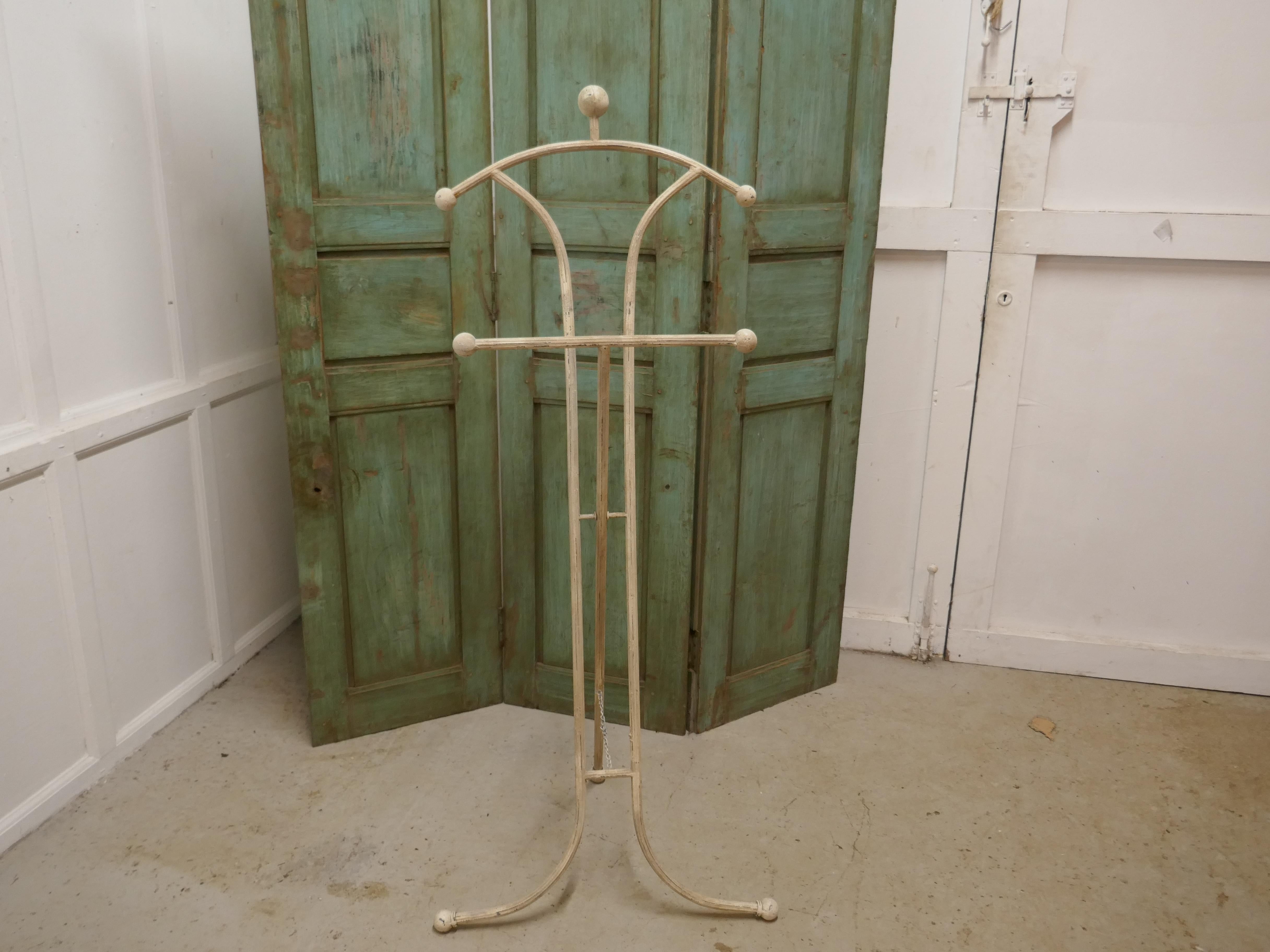 Unusual floor standing suit hanger or dumb valet

A very useful piece, the hanger or clothes stand is painted shabby white, it will accommodate either jacket and trousers or even a dress and there is also a hat hanger, this would make an excellent