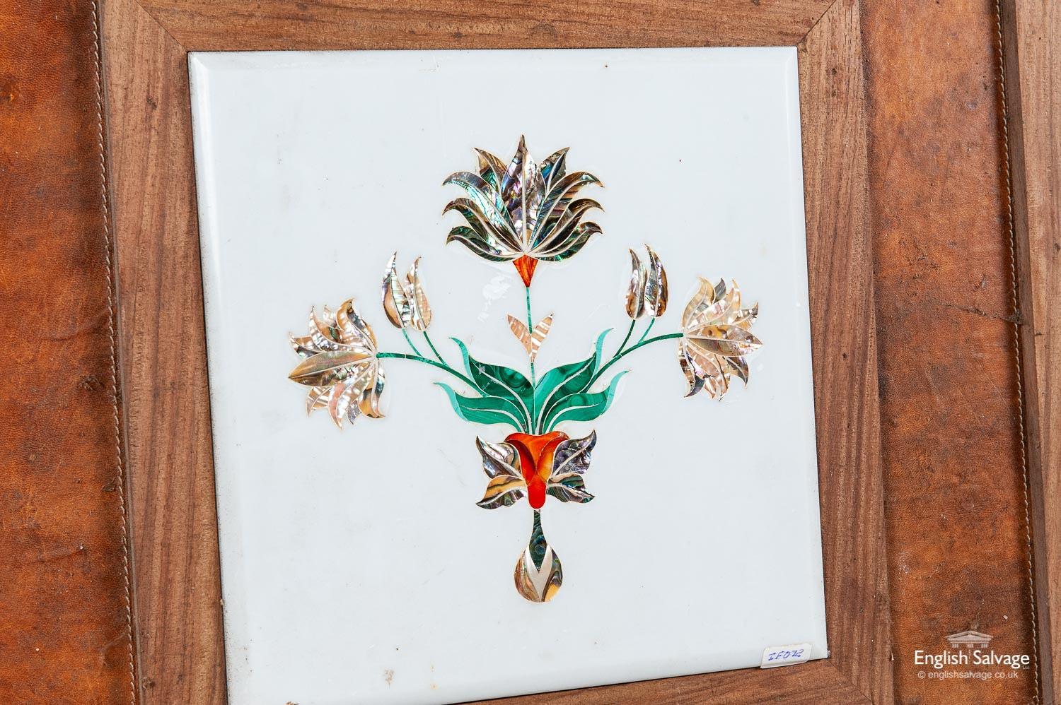 Attractive reclaimed wall hanging with a bevelled marble central plaque inlaid with mother of pearl, shells etc to form a very pretty floral and foliate design. Framed in a heavy and substantial hardwood frame covered in a tan colored and stitched