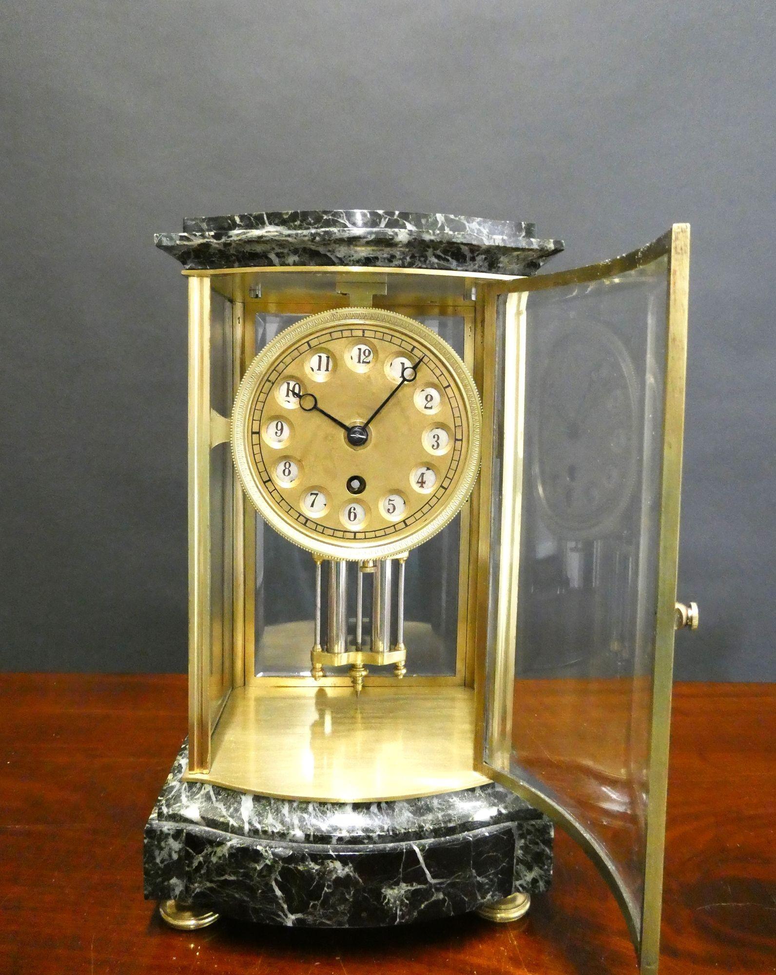 Unusual French 24 Hour Four Glass Mantel Clock

French four glass clock housed in a bow fronted brass case with beautifully figured marble top and base standing on decorative brass bun feet with bow fronted front glass.
Gilded and chased bezel,