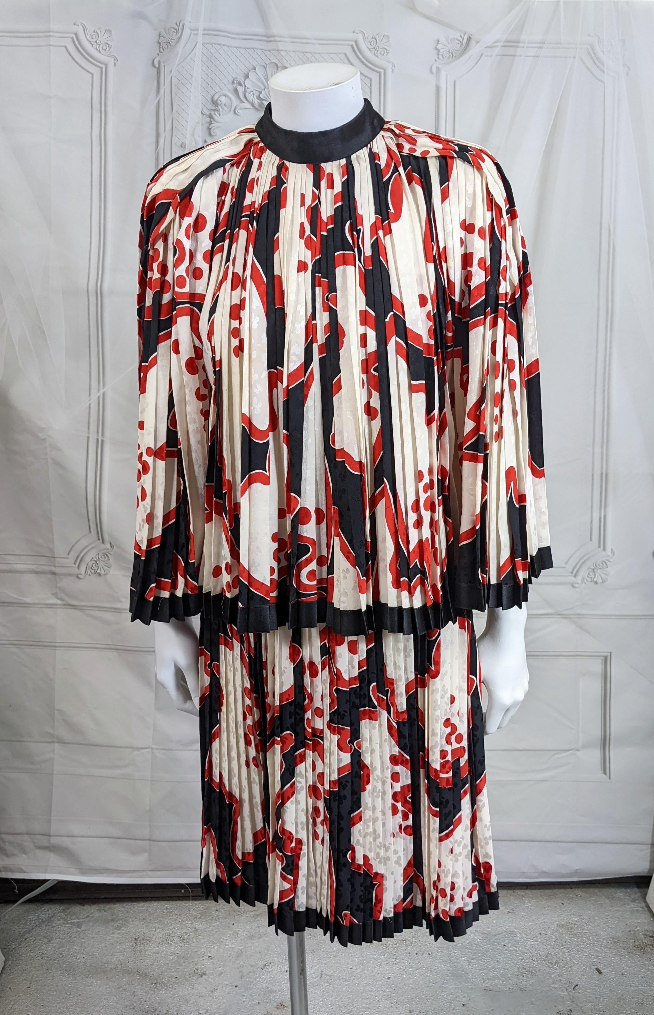 Elegant Galanos Silk Crepe 2 piece pleated dress. Unusual design from Galanos. The printed black/red silk crepe is pleated from the waist and neckline and edged in black satin ribbon. James Galanos's garments are beautifully constructed inside and
