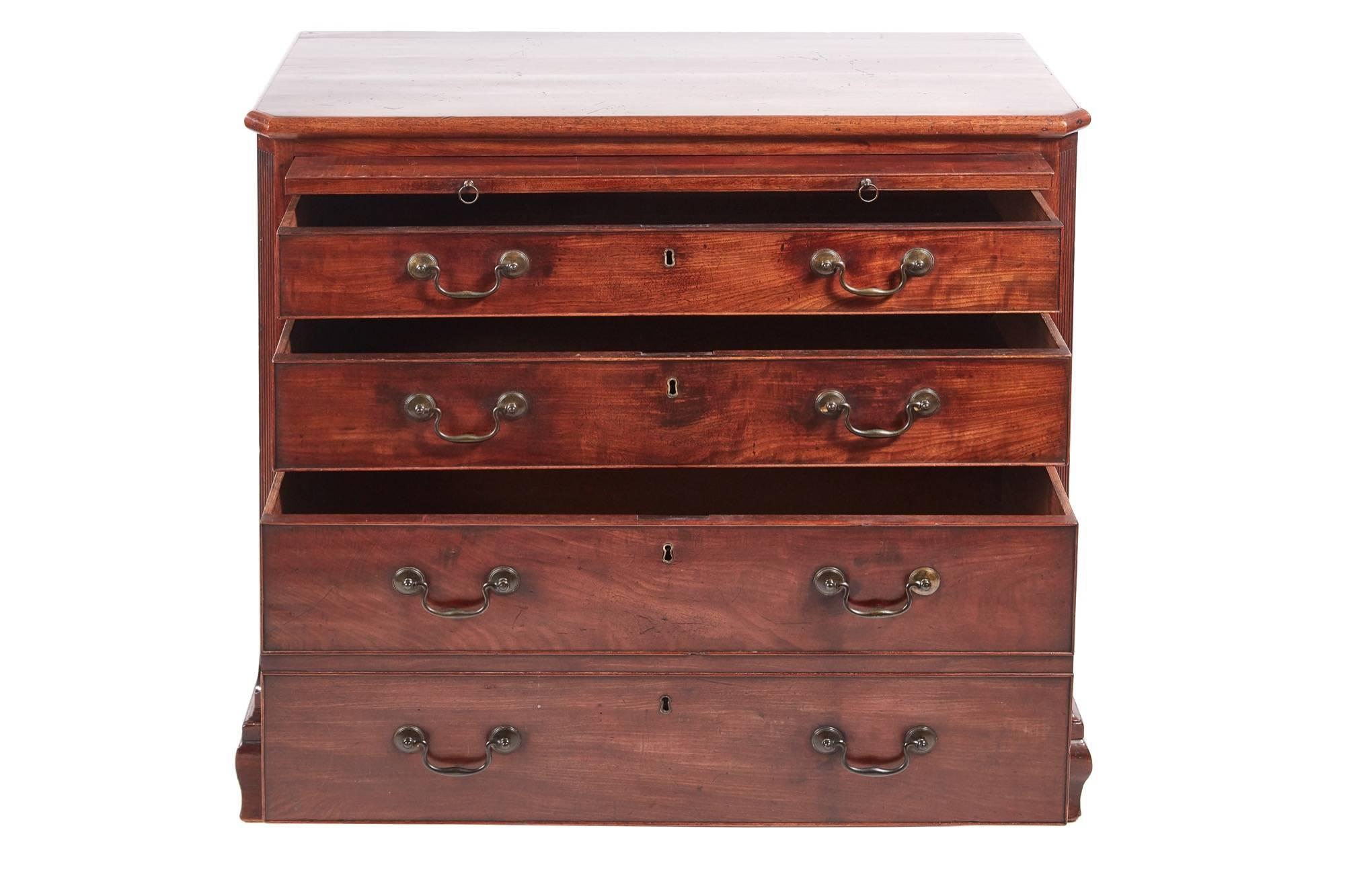 Unusual George III mahogany chest of drawers with a lovely mahogany top, brushing slide, reeded canted corners, unusual drawer configuration two long drawers and one hat drawer all with original brass handles, standing on original ogee bracket feet.