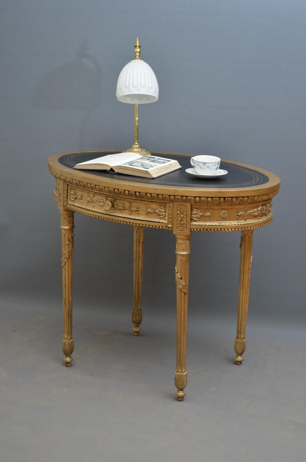 Sn3644, elegant Victorian giltwood side table, writing table of oval design, having black tooled leather top with dart and egg carved edge and finely carved frieze with practical drawers, all standing on slender, fluted legs with leafy carving