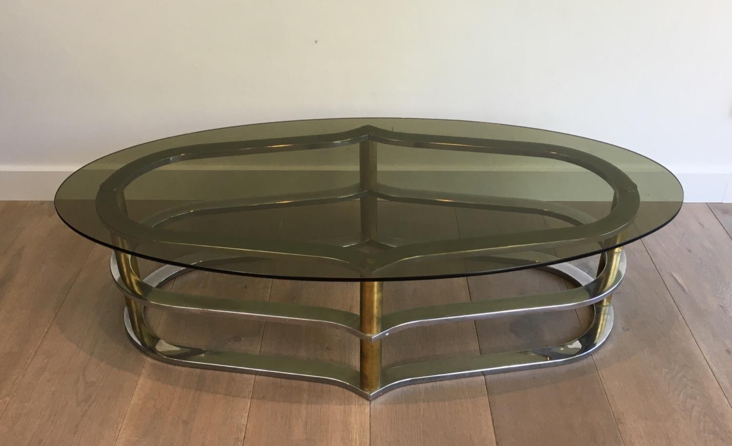 This unusual design coffee table is made of gilt brass and chrome. This cocktail table is a very unusual model of very good quality. This is a French work, circa 1960.