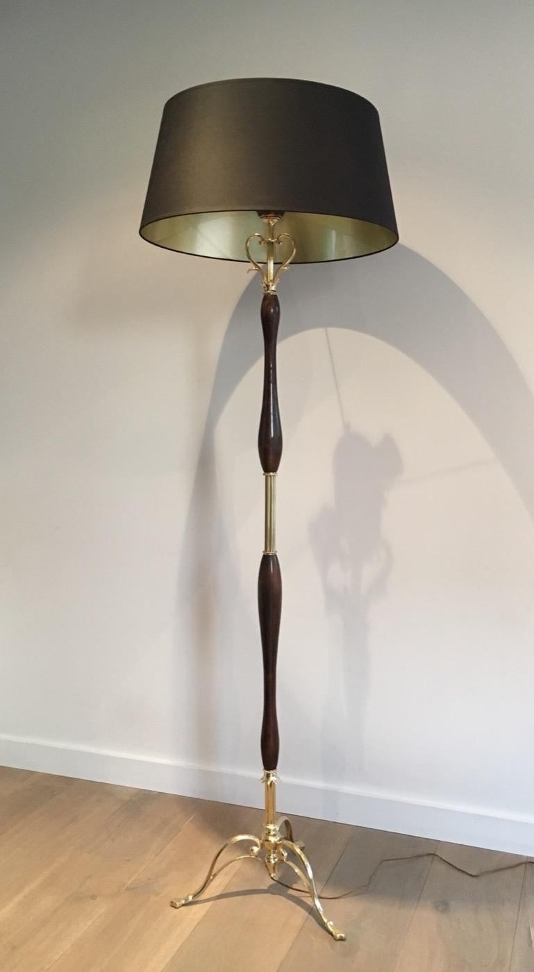This unusual floor lamp is made of gold gilt brass and wood. The shade is made of black shintz, gold inside. It is French, circa 1940.
