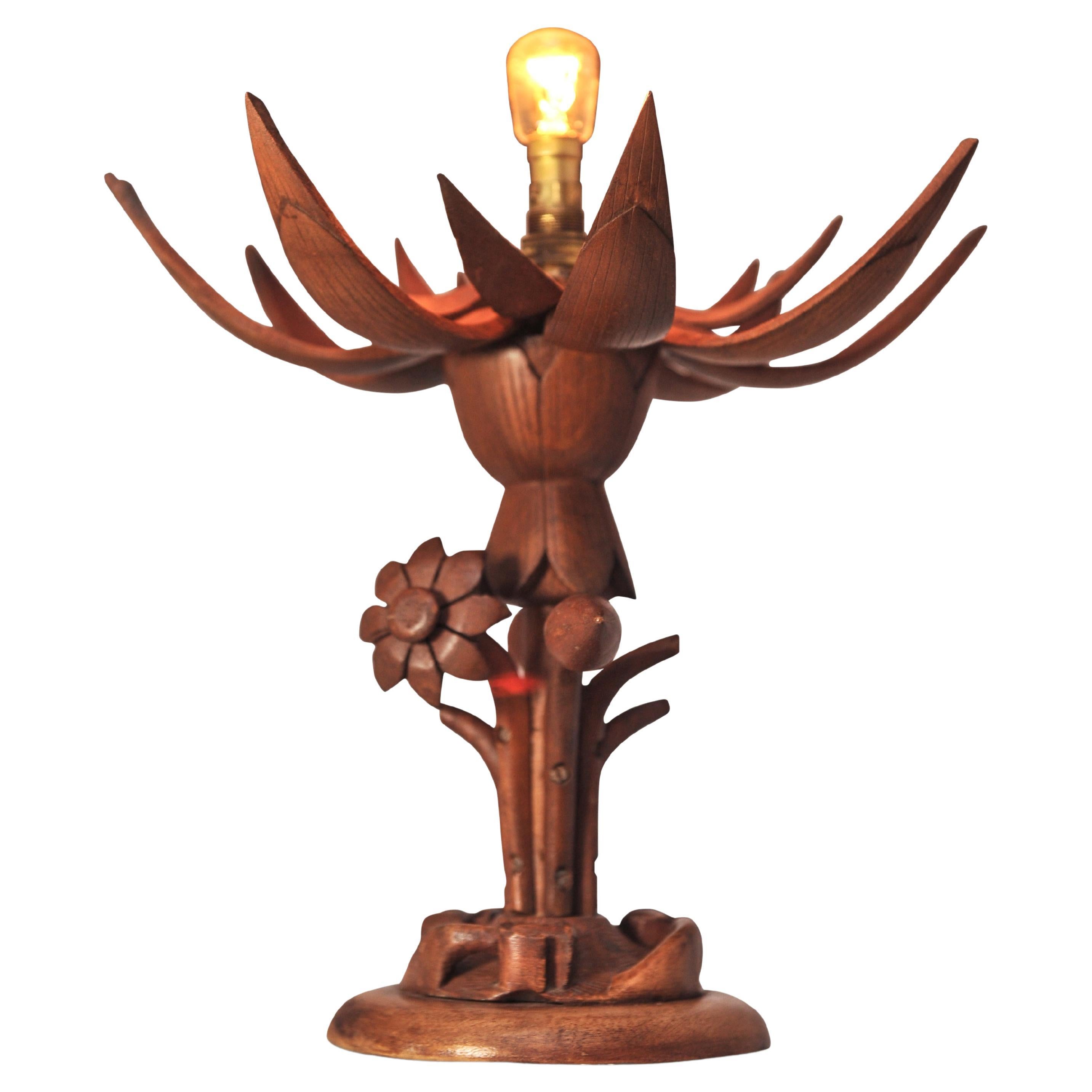 A Hand Made, Organic Hand Carved Wood Lotus Flower Table Lamp, With Petals That Retract To Reveal The Light.

A unique piece, that's both at once whimsical and also arts and crafts.

