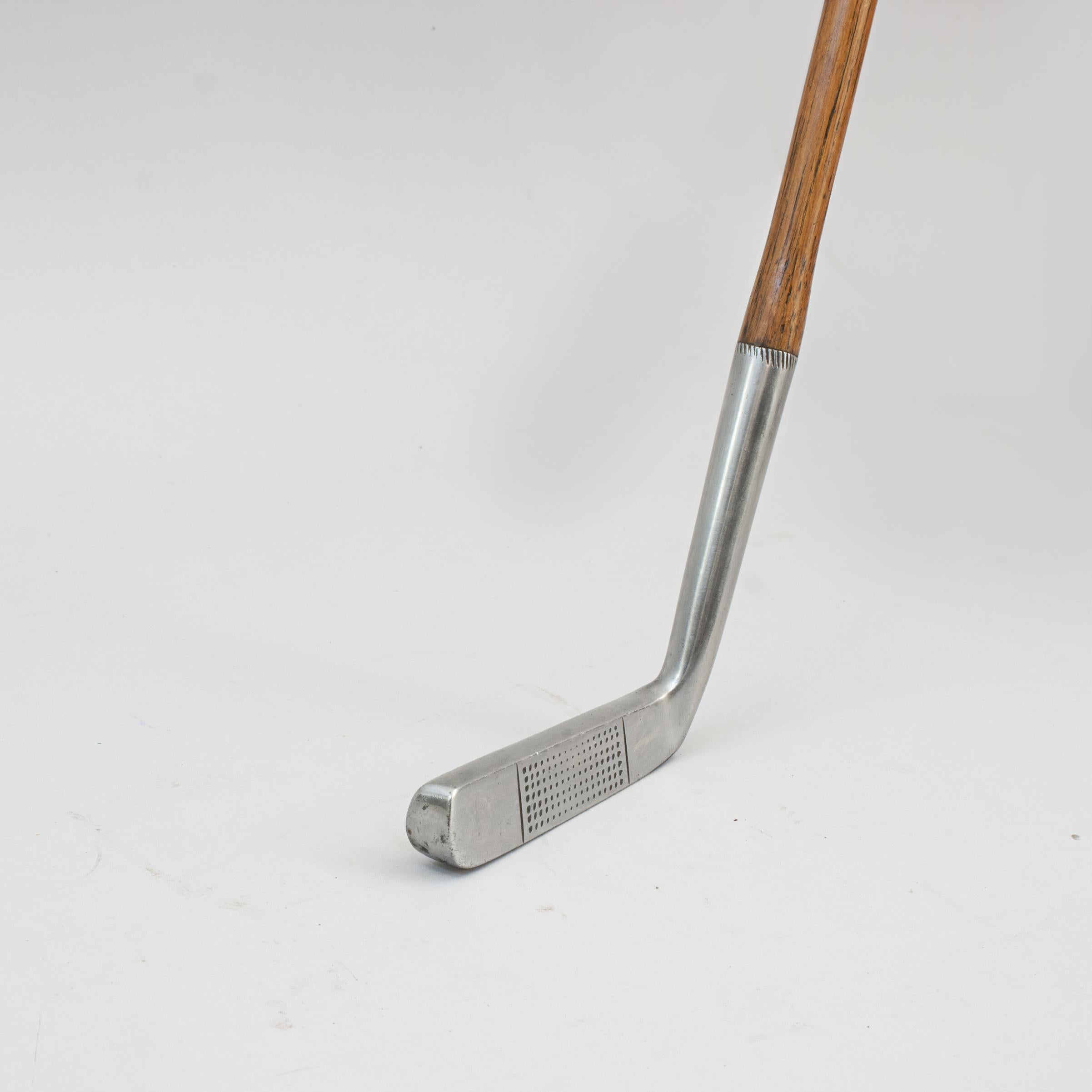 Vintage Narrow Face Spalding Putter.
A fine and nicely weighted dot punched faced putter by A.G. Spalding & Bros. The hickory shaft with new polished leather grip, the rear of the club head marked with Spaldings 'Anvil' cleek mark and 'Hand Forged,