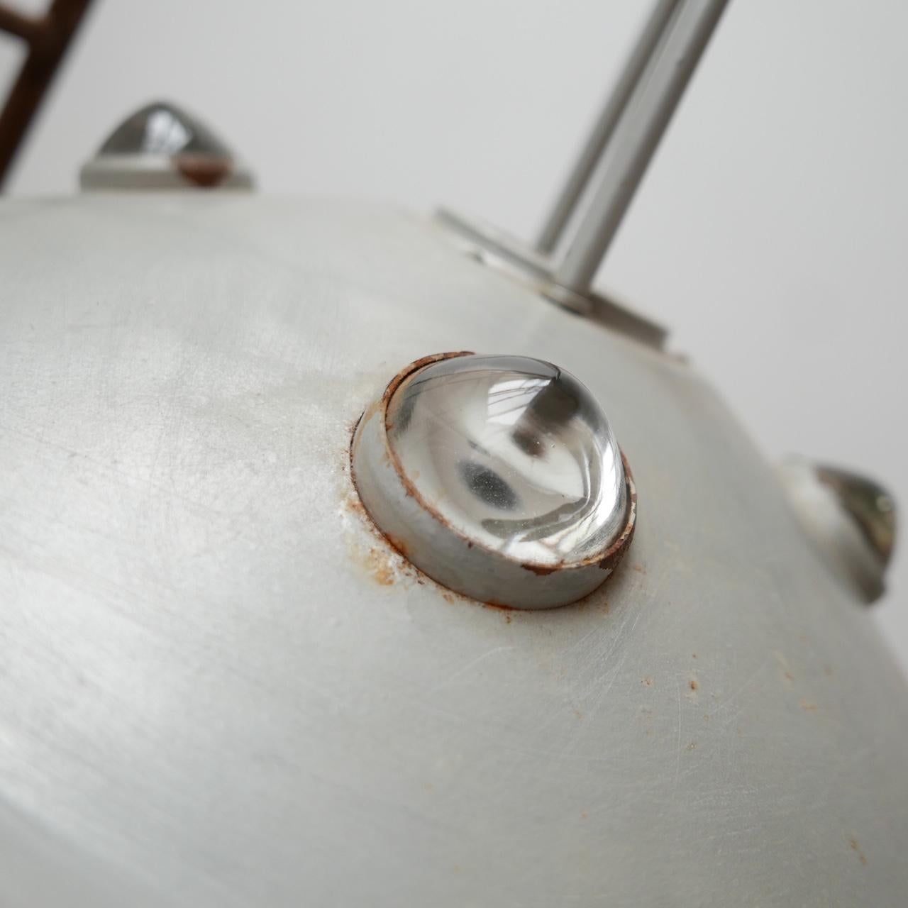 A very scarce run of industrial pendant lights in the form of flying saucers. 

Originally from a factory in England. 

There are four glass roundels to the top and one large one to the base to diffuse light. 

We have never seen a lighting
