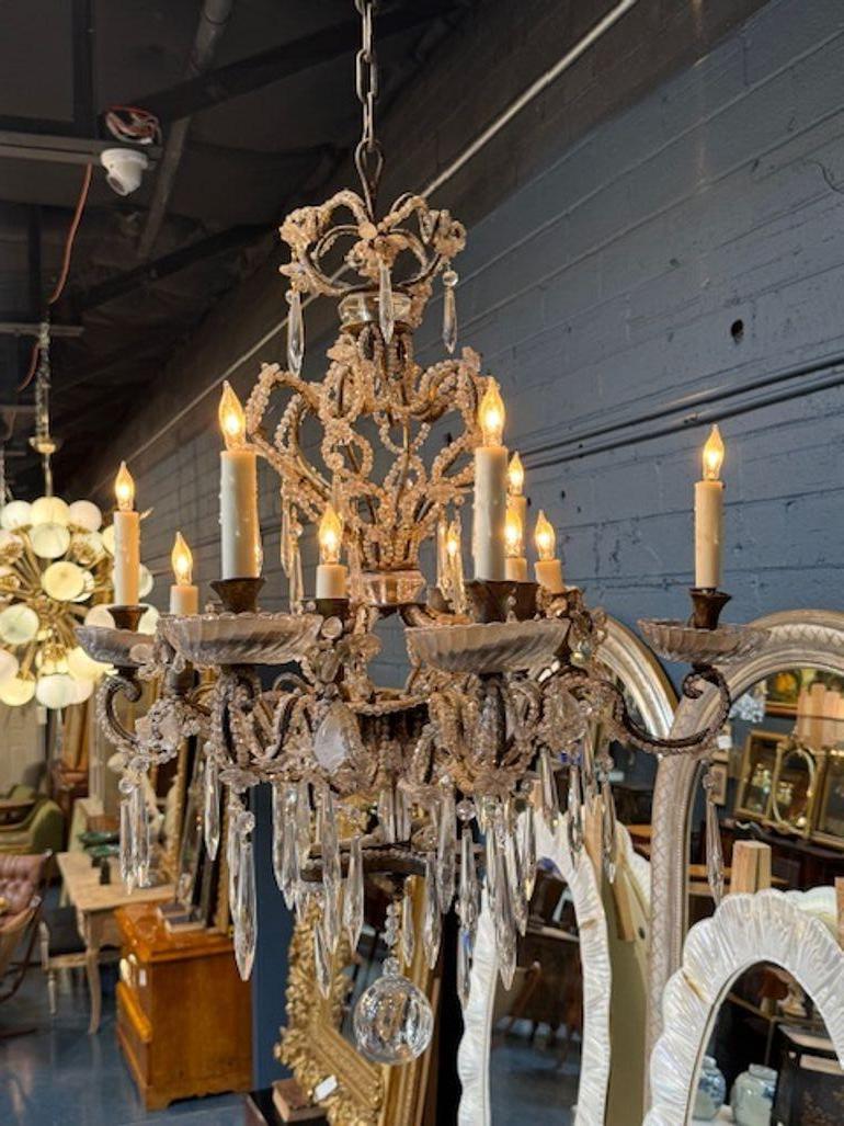 Unusual 20th century Italian beaded crystal chandelier in the manner of Bagues. Circa 1920.  The chandelier has been professionally rewired, comes with matching chain and canopy. It is ready to hang! Italian origin, Baguès-inspired: These