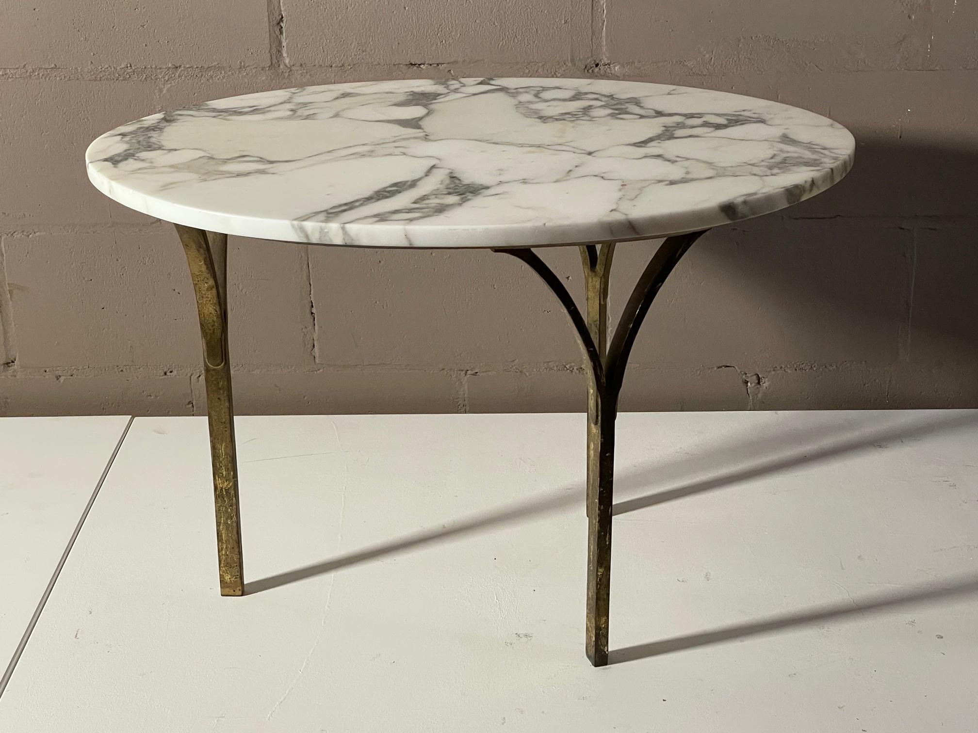 An unusual Italian side table with marble top and bronze Y shaped legs. The legs are solid bronze-heavy and have a nice patina.