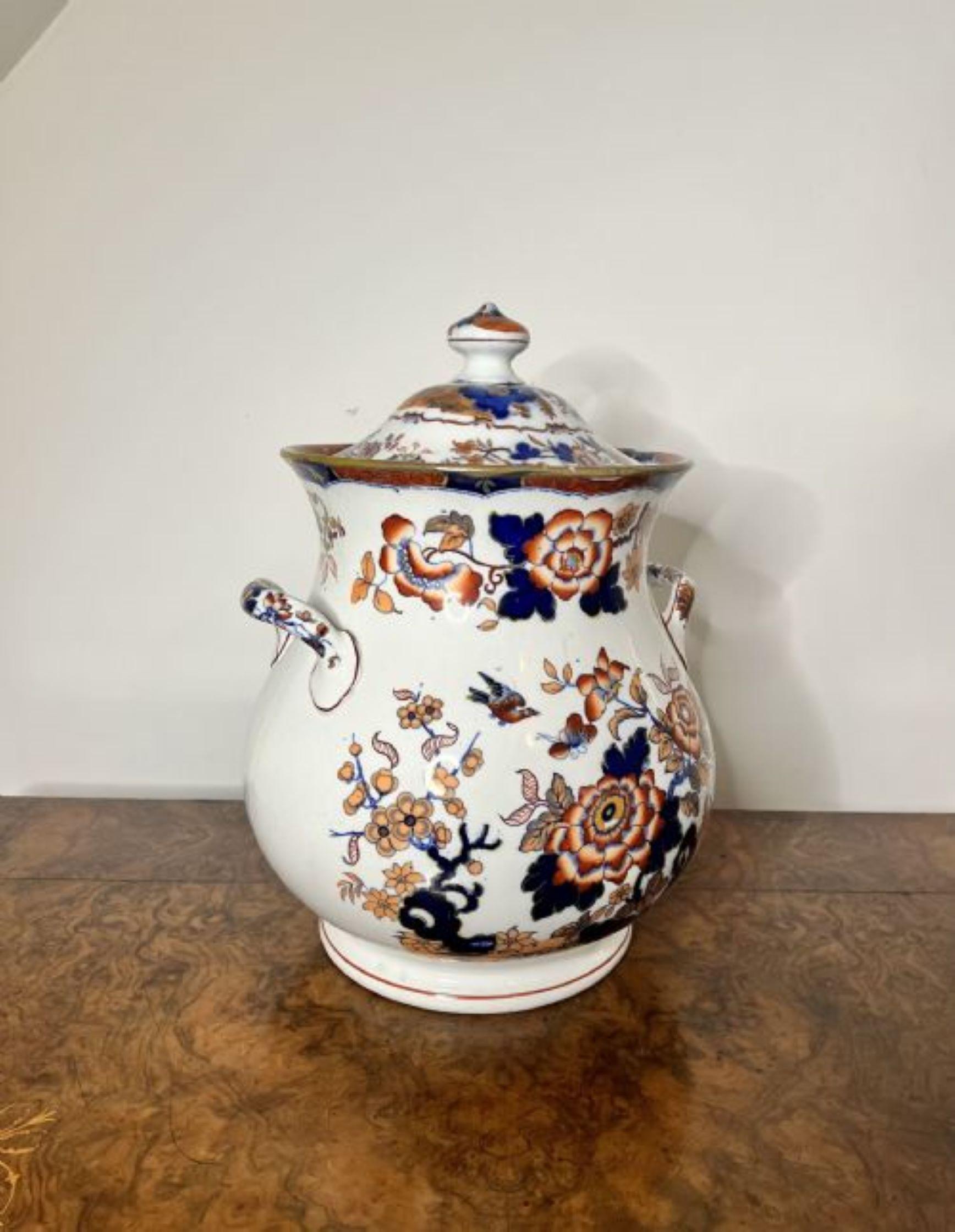 Unusual large antique Japanese imari lidded vase having a quality antique imari lidded vase, with twin handles to the sides, a bulbous body shape and a removable lid, decorated with flowers on a white ground hand painted in orange, red and blue