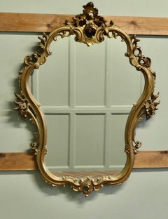 Unusual Large Rococo Style Gilt Wall Mirror  The Mirror has an elaborate shape