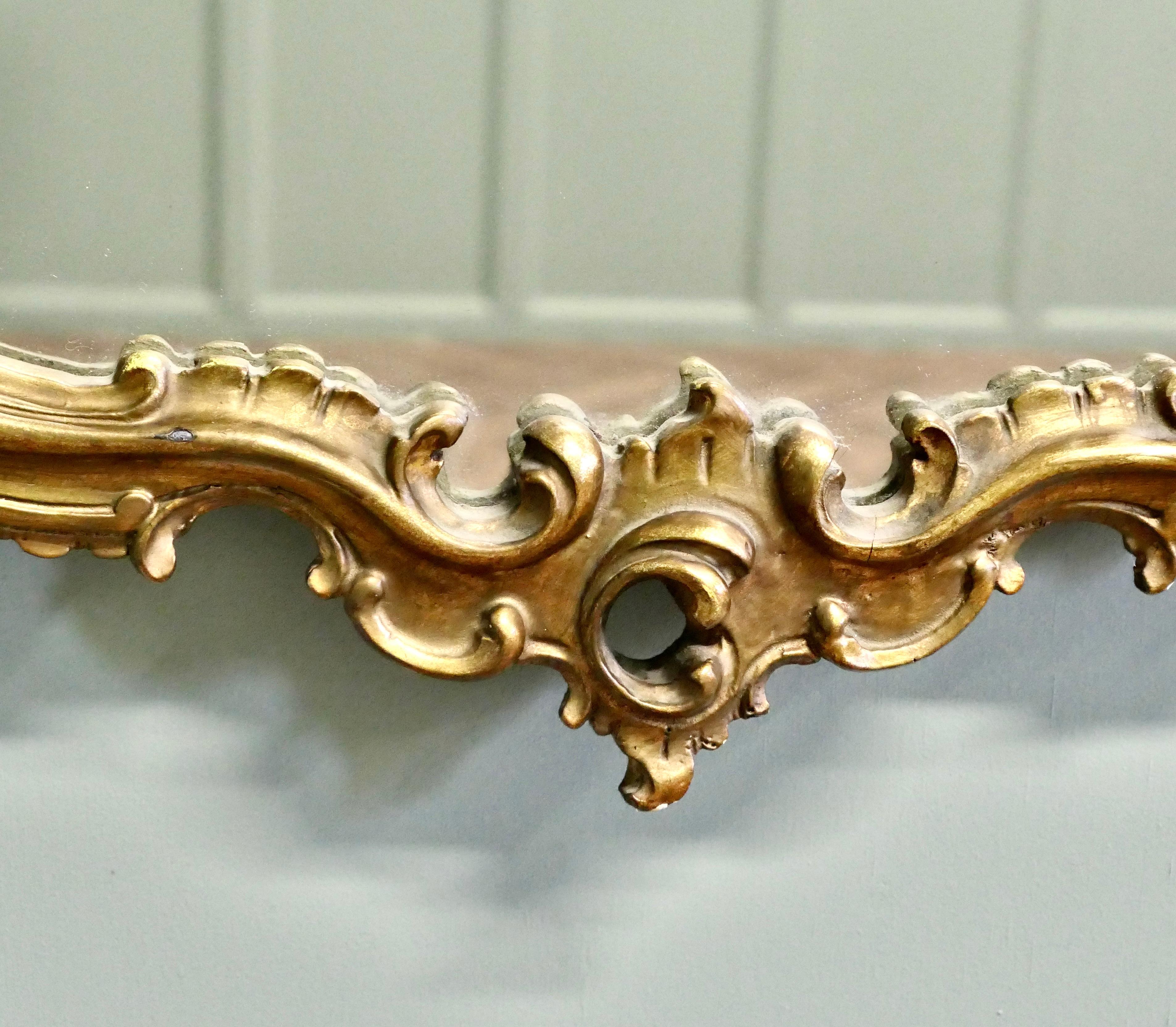 Mid-20th Century Unusual Large Rococo Style Gilt Wall Mirror  The Mirror has an elaborate shape For Sale