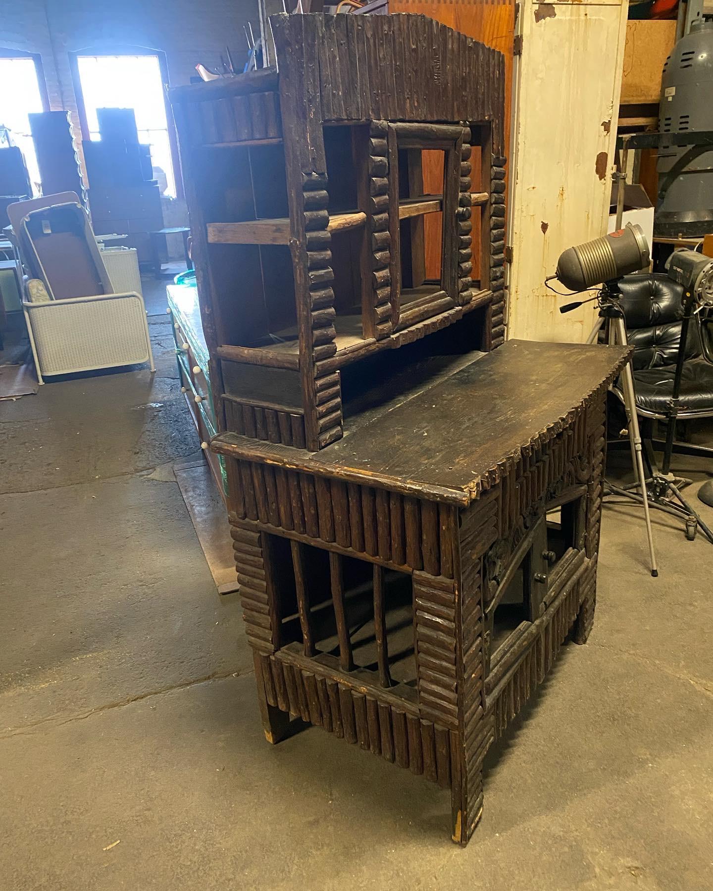 Most unusual and large rustic late 19th century adirondak hutch / cabinet. Tree,twig center door and shelves (top) drawer and two doors (bottom)amazing quality and construction. Not certain but most likely had glass when originally built. Hand