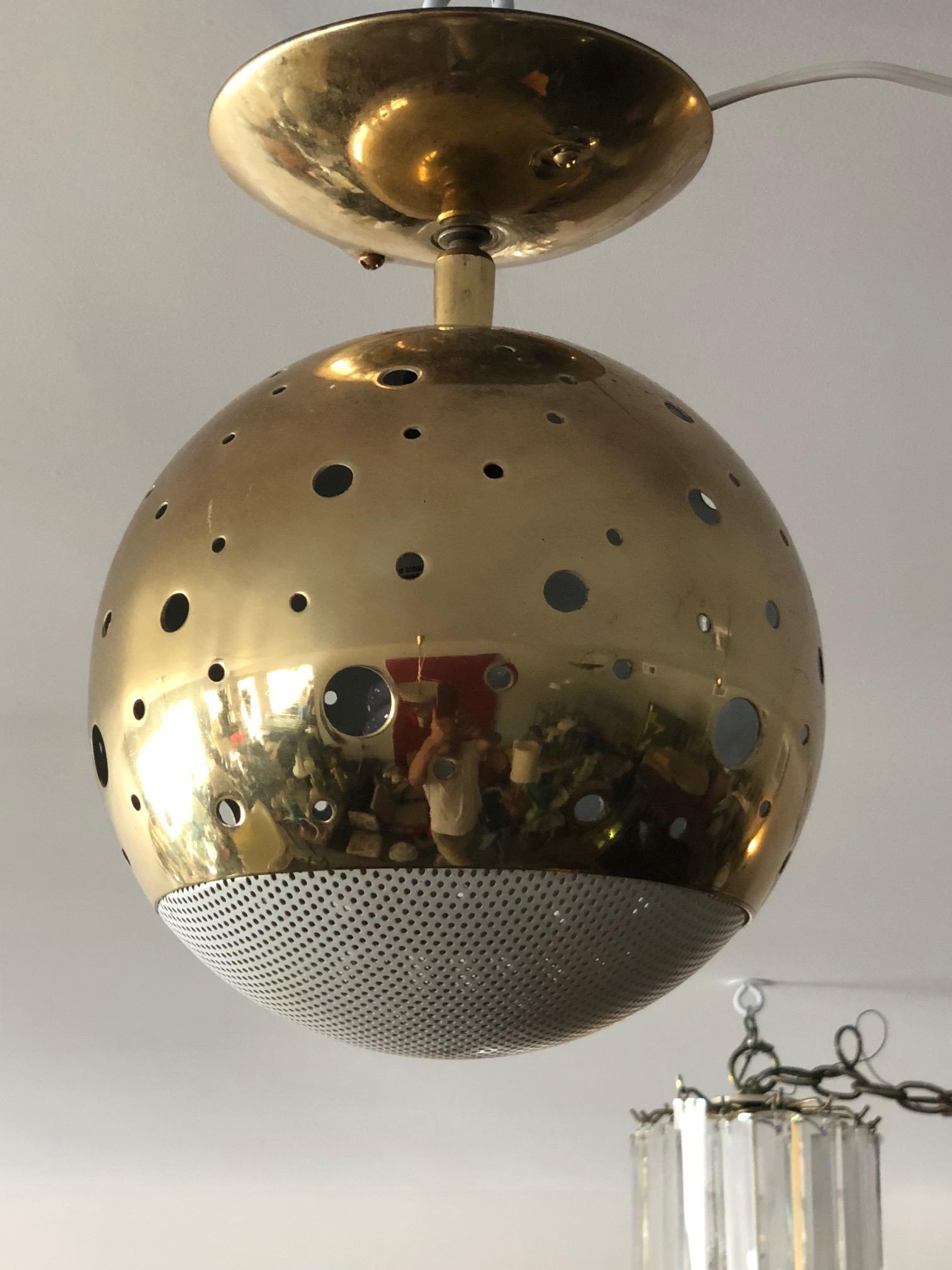 A unusual Lightolier pendant in brass with porthole cut outs and perforated white metal shade.