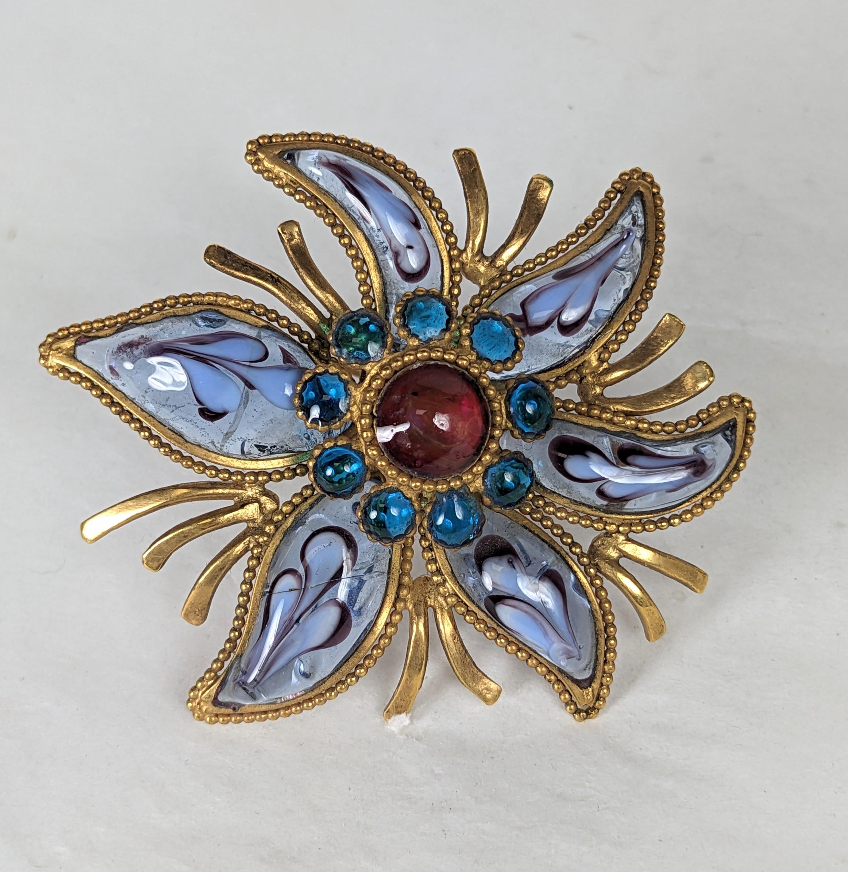 Unusual Maison Gripoix Starfish Brooch from the 1960's. Hand made poured glass with distinctive feather work glass in petals with center of ruby and aquamarine glass cabochons. Elaborate metal work with beaded setting in antique bronze finish. 2.75