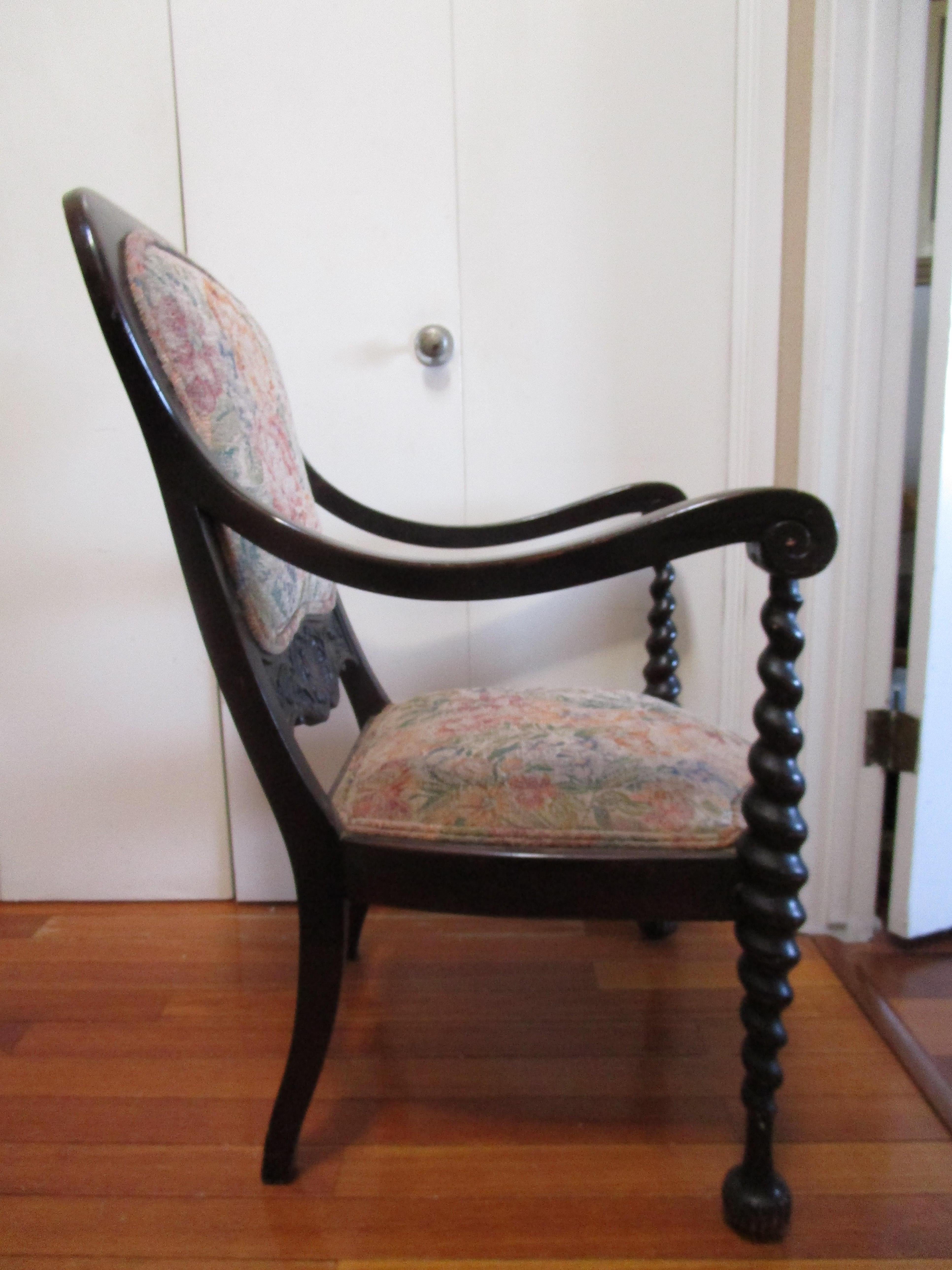 Beautiful turned front legs, vintage tapestry upholstery, and ebonized carved wood combine to make this mannerist revival chair worth a second look. The piece interesting chair - and seems to combine elements of different styles. It is definitely