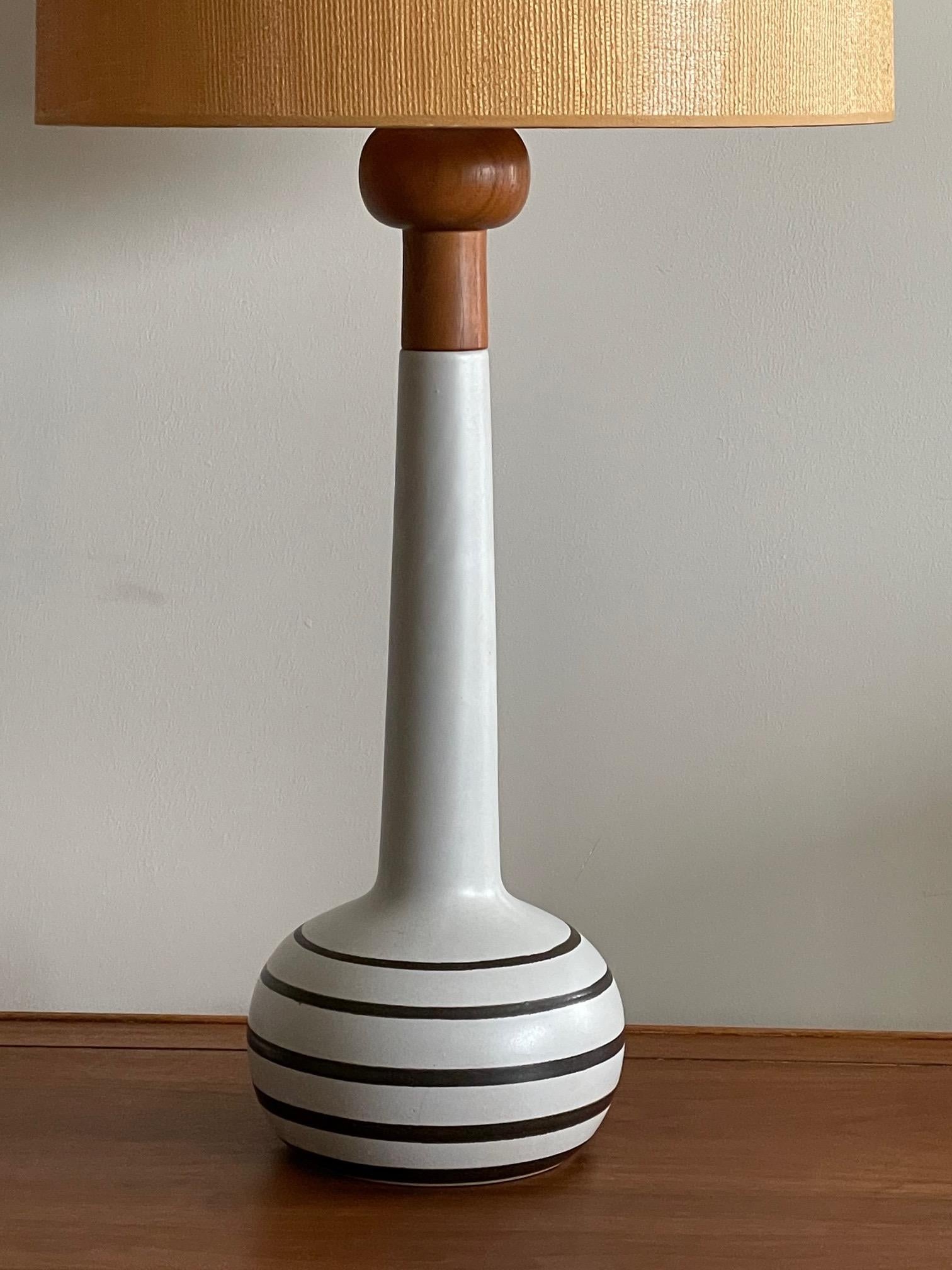 An unusual striped lamp by Martz, with original linen shade. Measures: Total height to top of finial is 32
