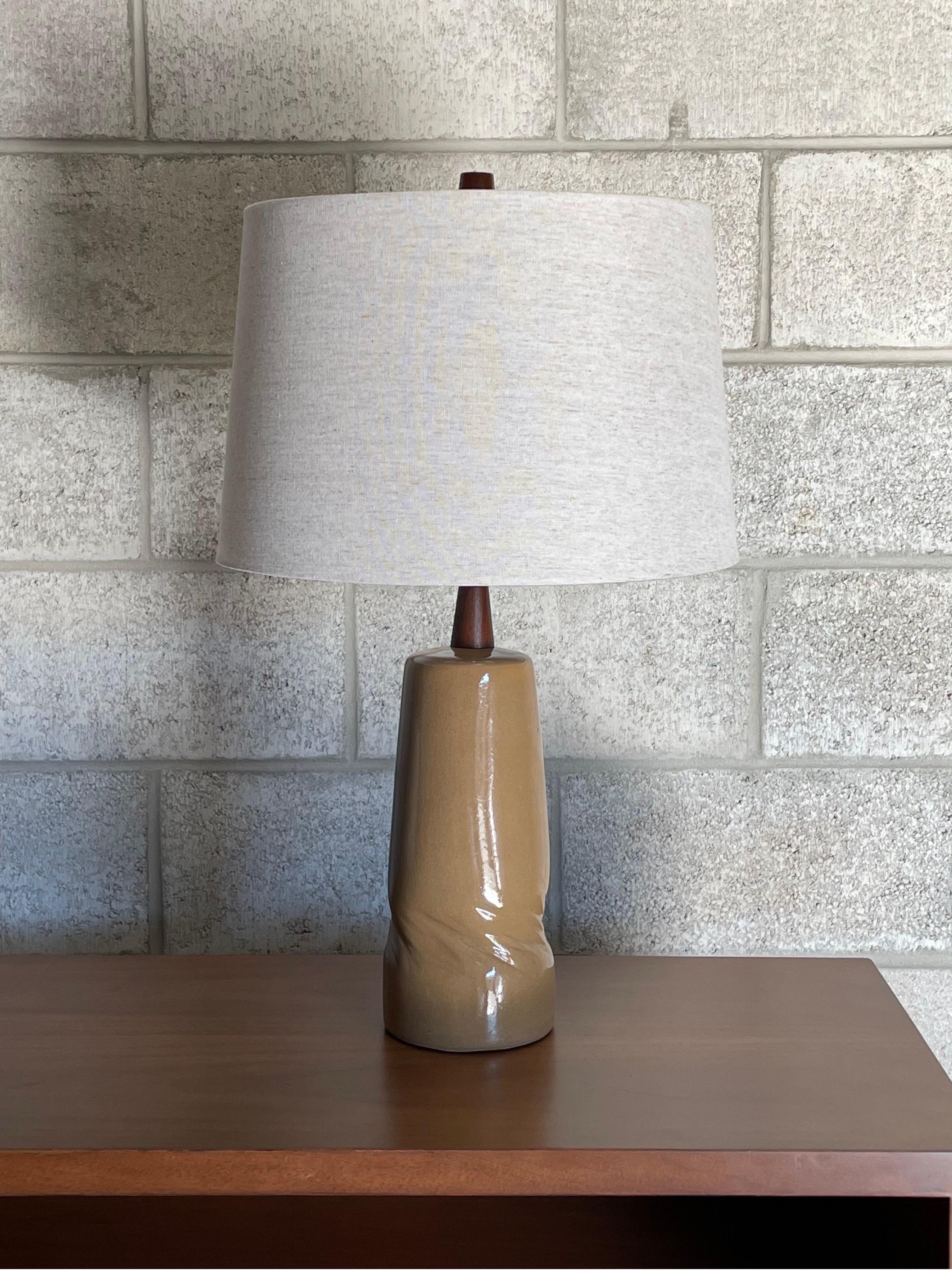 Table lamp by ceramicist duo Jane and Gordon Martz for Marshall Studios. Unusual ochre like color with interesting and unusual twisted detail. Unique design adds great movement and depth to the lamp. 

Measures: 
Overall 
24.5” tall 
15” wide