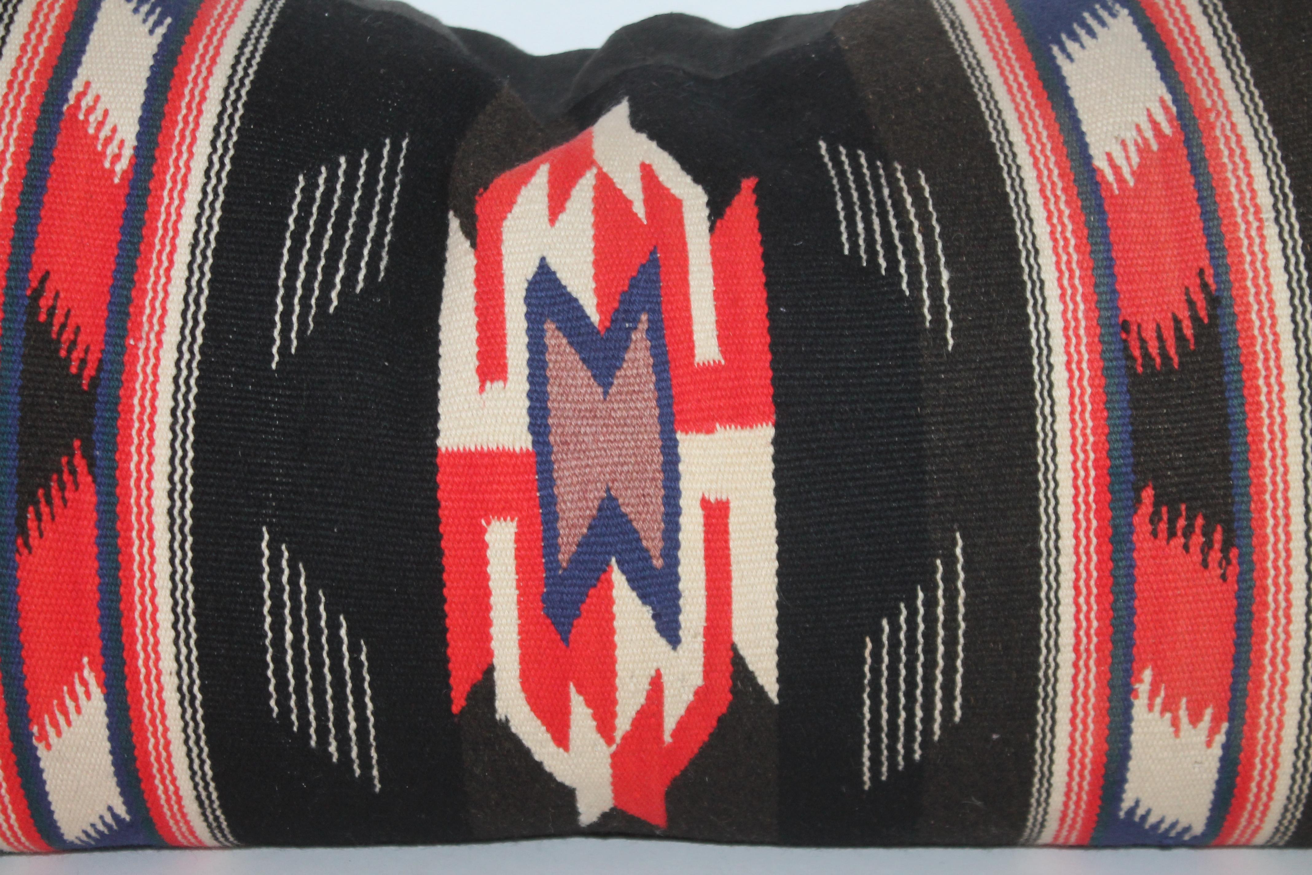Unusual Mexican Serape pillow with white fringe and black linen backing.