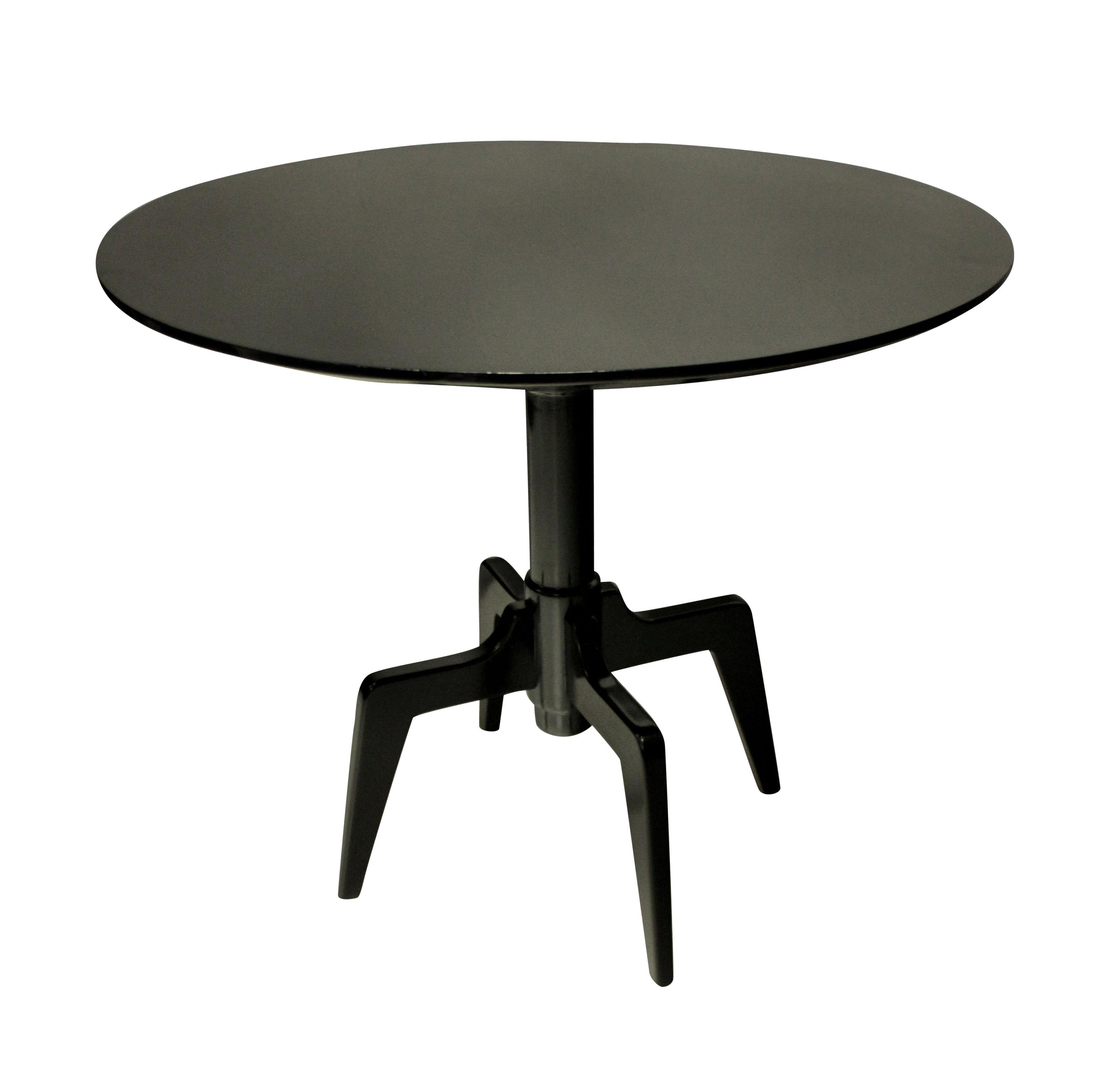 An unusual Italian mid-century, ebonized cherrywood centre table on raised articulated legs.