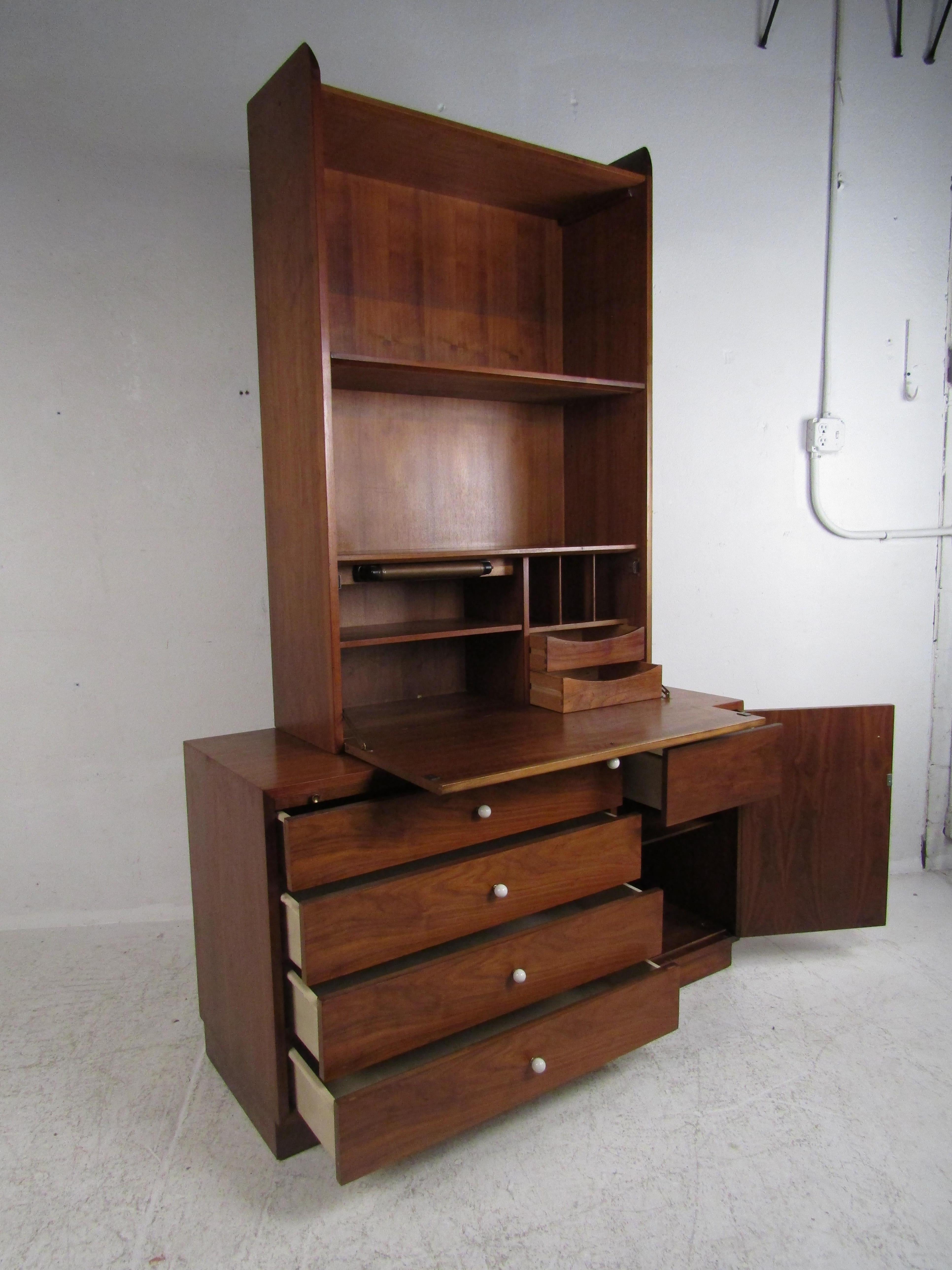 A beautiful vintage modern wall unit that consists of two pieces. A unique design that offers plenty of storage without sacrificing style. Sturdy construction, elegant walnut wood grain, and iconic round white drawer pulls show quality midcentury