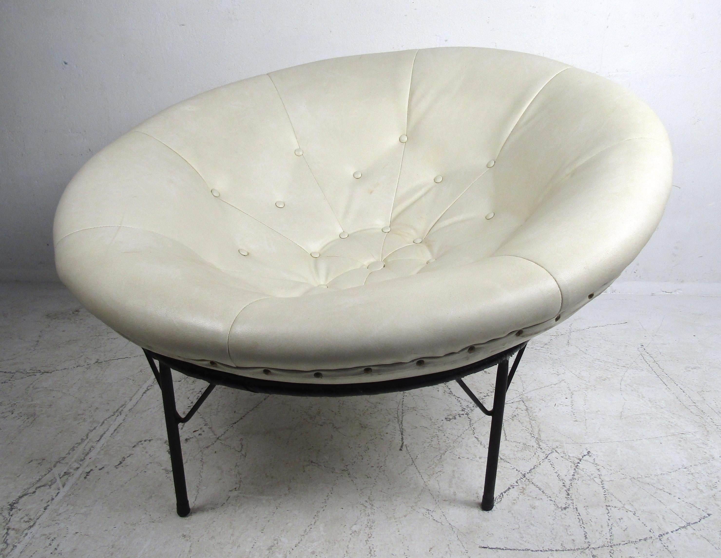 This stunning vintage modern bowl chair has a unique design that allows a large circular leather seat to rest inside of a sturdy round base. The tufted white leather seat contours the body perfectly ensuring maximum comfort. Please confirm item