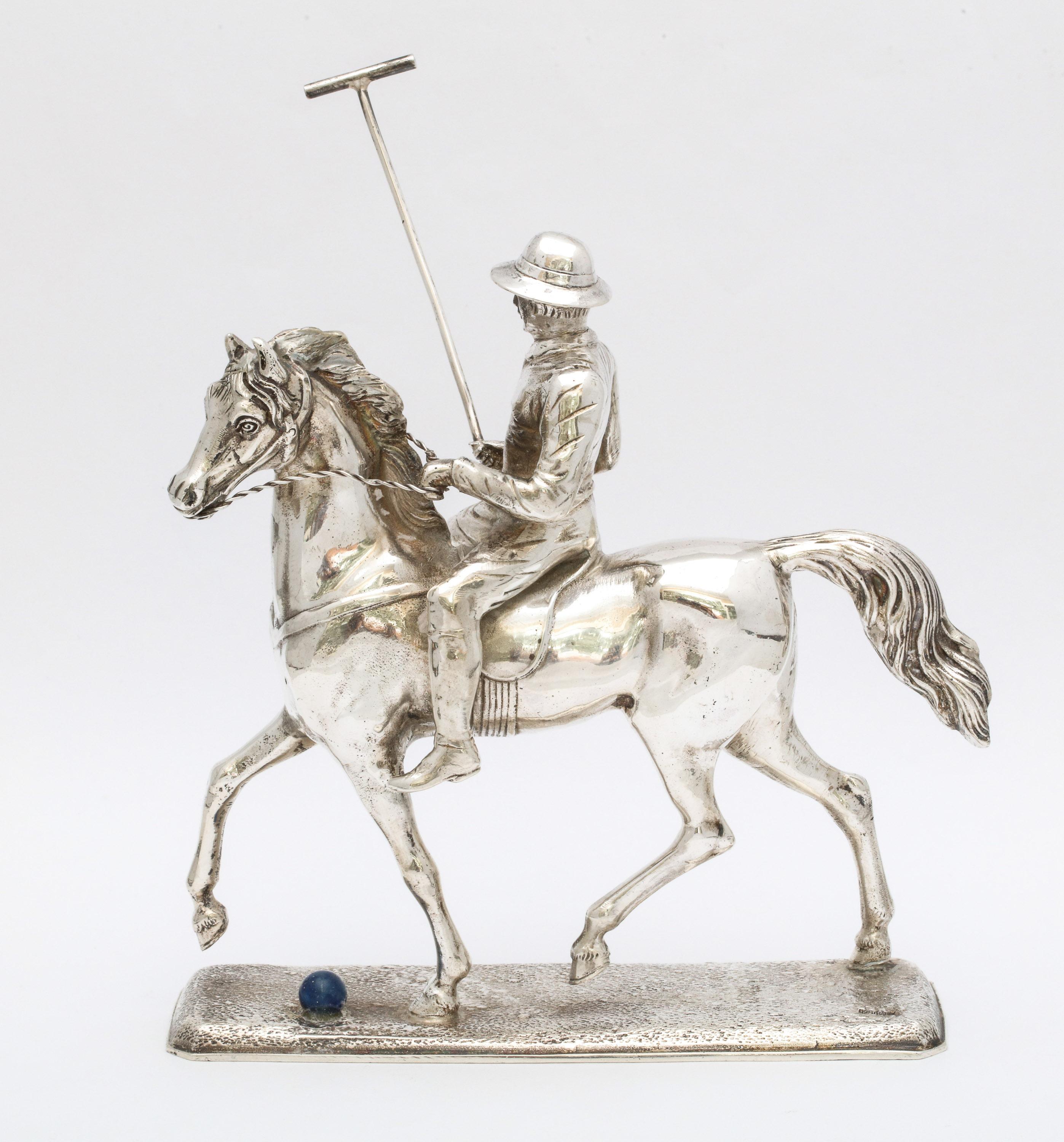 Unusual, Mid-Century Modern sterling silver statuette of a polo player mounted on his horse and holding a polo mallet, Germany, circa 1950s. There is a lapis lazuli polo ball near the horse's front hooves. Measures 7 inches high (to top of mallet) x